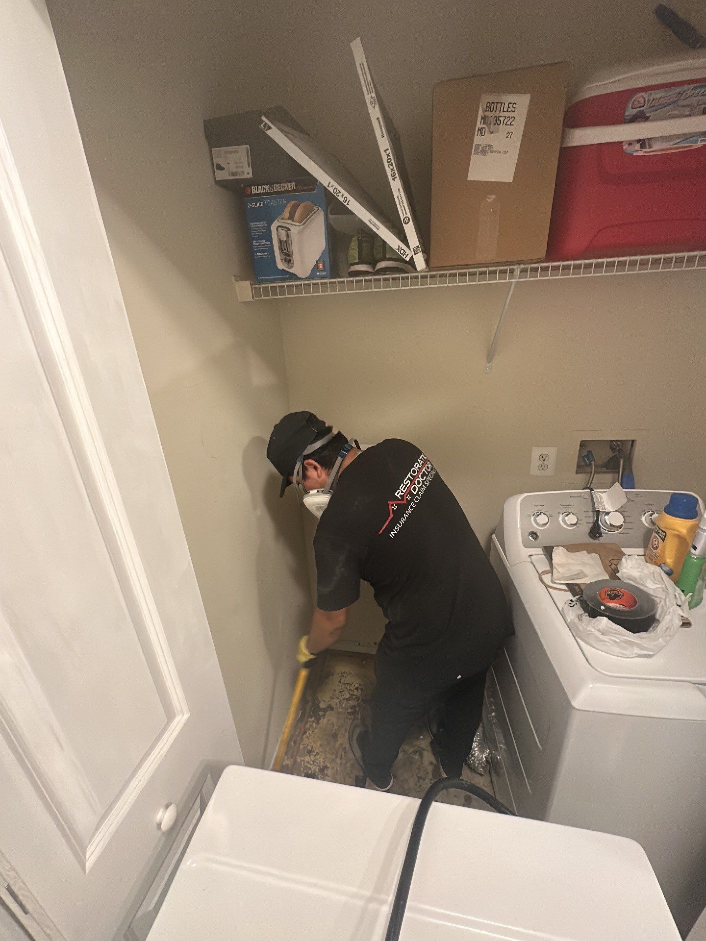 Water damage restoration in Reston: dehumidifier and drying equipment positioned in affected interior space during initial assessment phase.