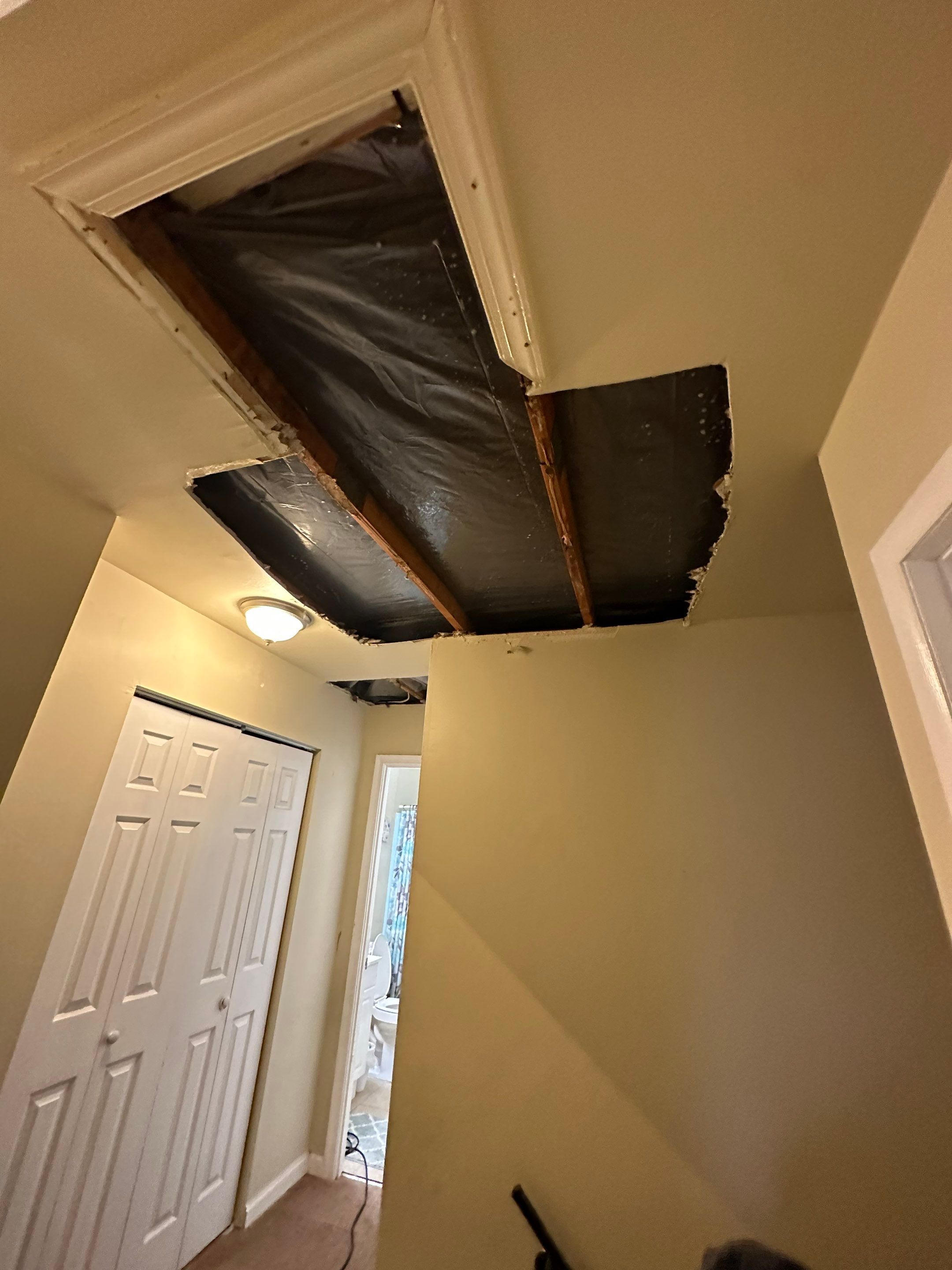 Dehumidifier and air movers deployed across affected area during water damage restoration drying phase.