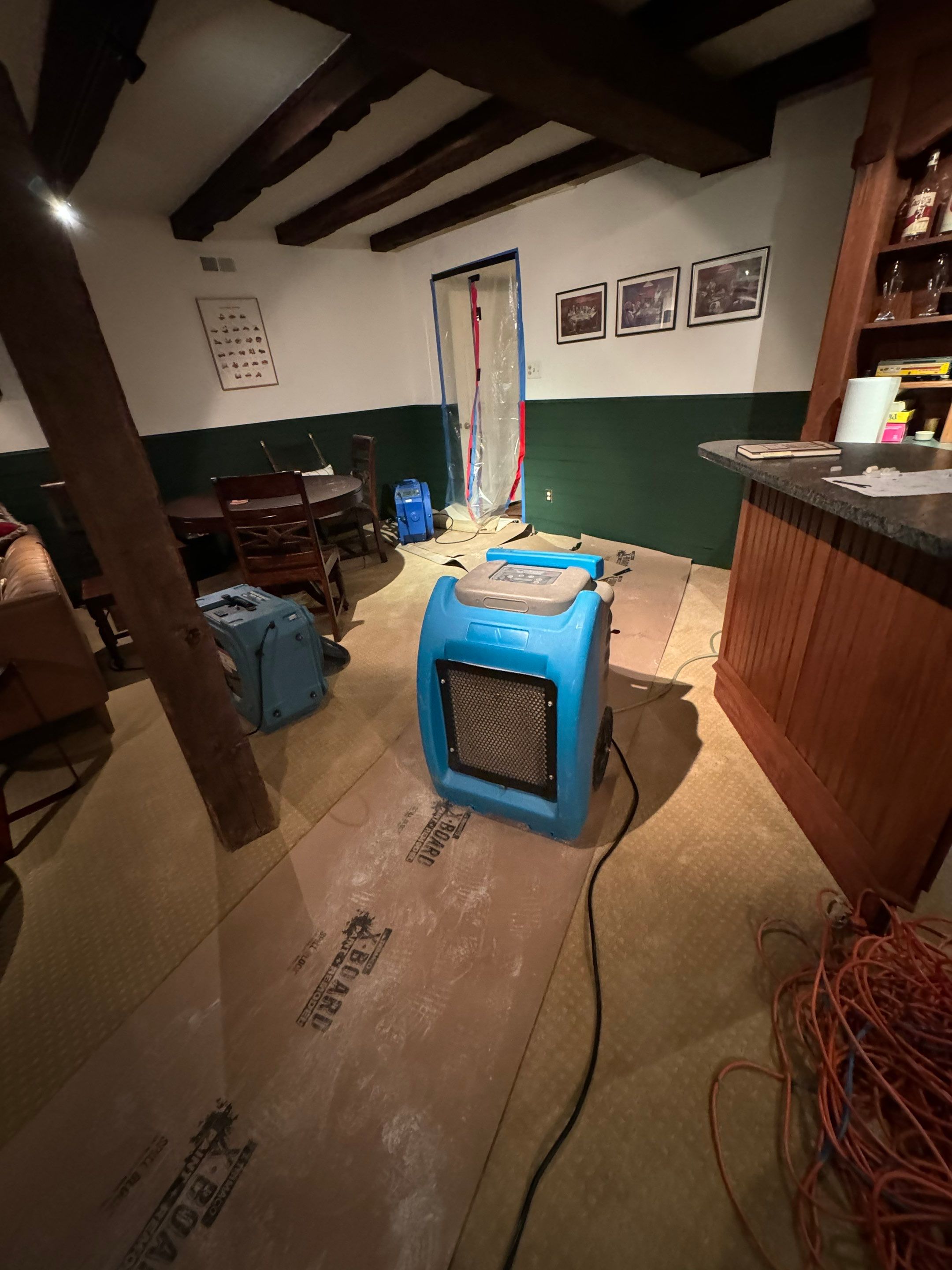 Dehumidification equipment positioned during mid-stage drying phase of water damage restoration.