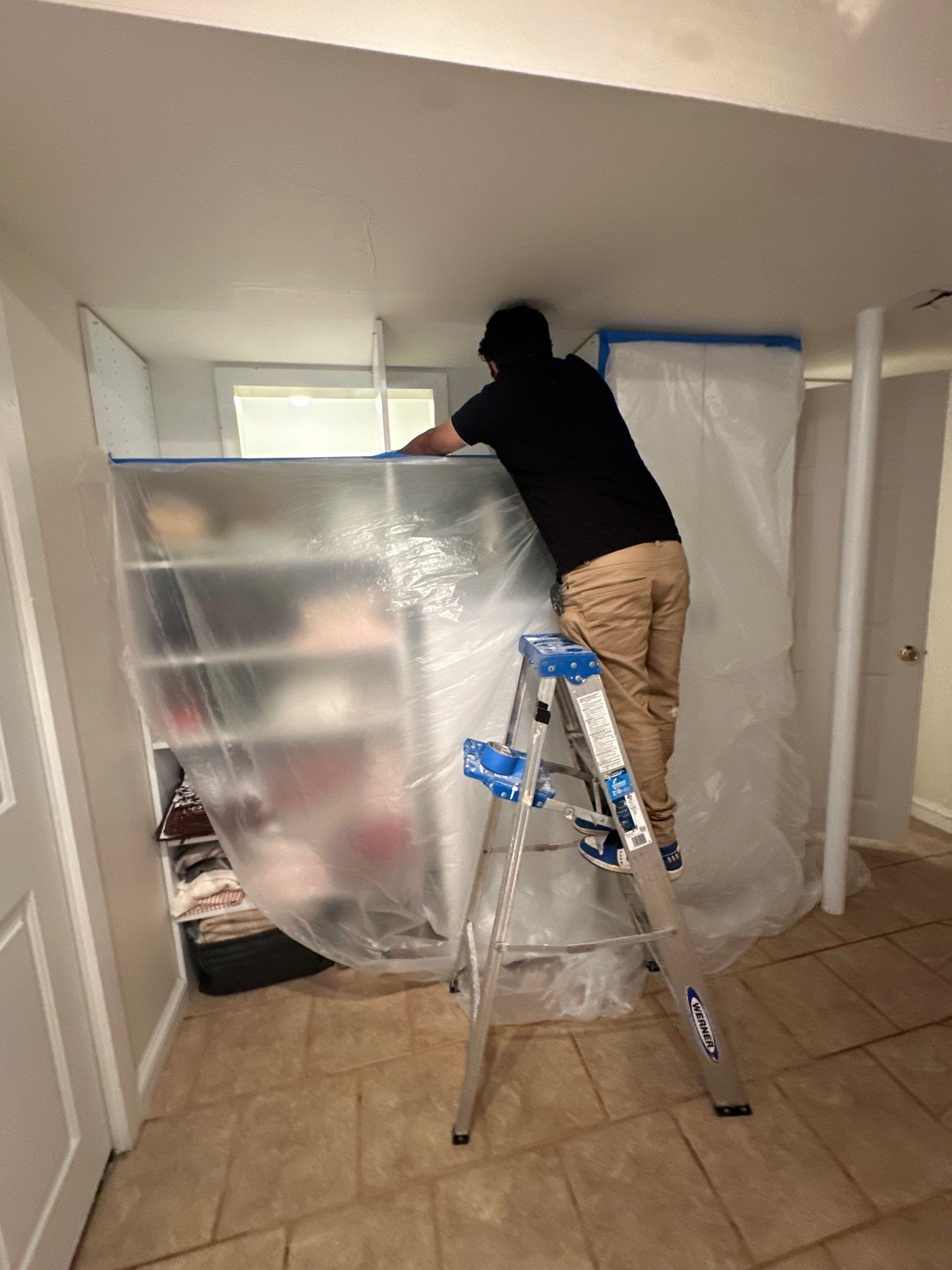 Standing water extraction underway in McLean water damage restoration, wet flooring visible.