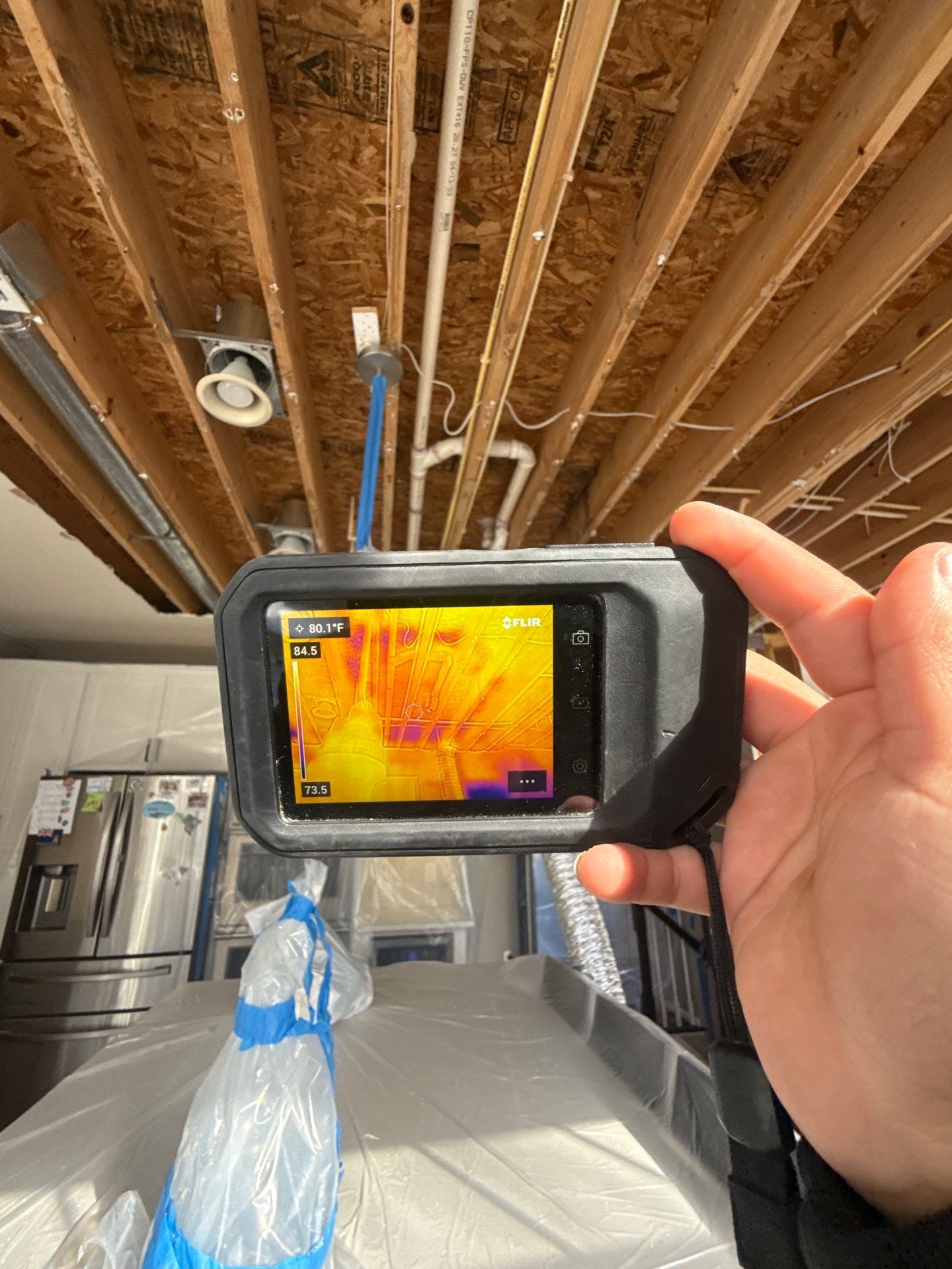 Technician applying antimicrobial treatment to remediated ceiling surface.