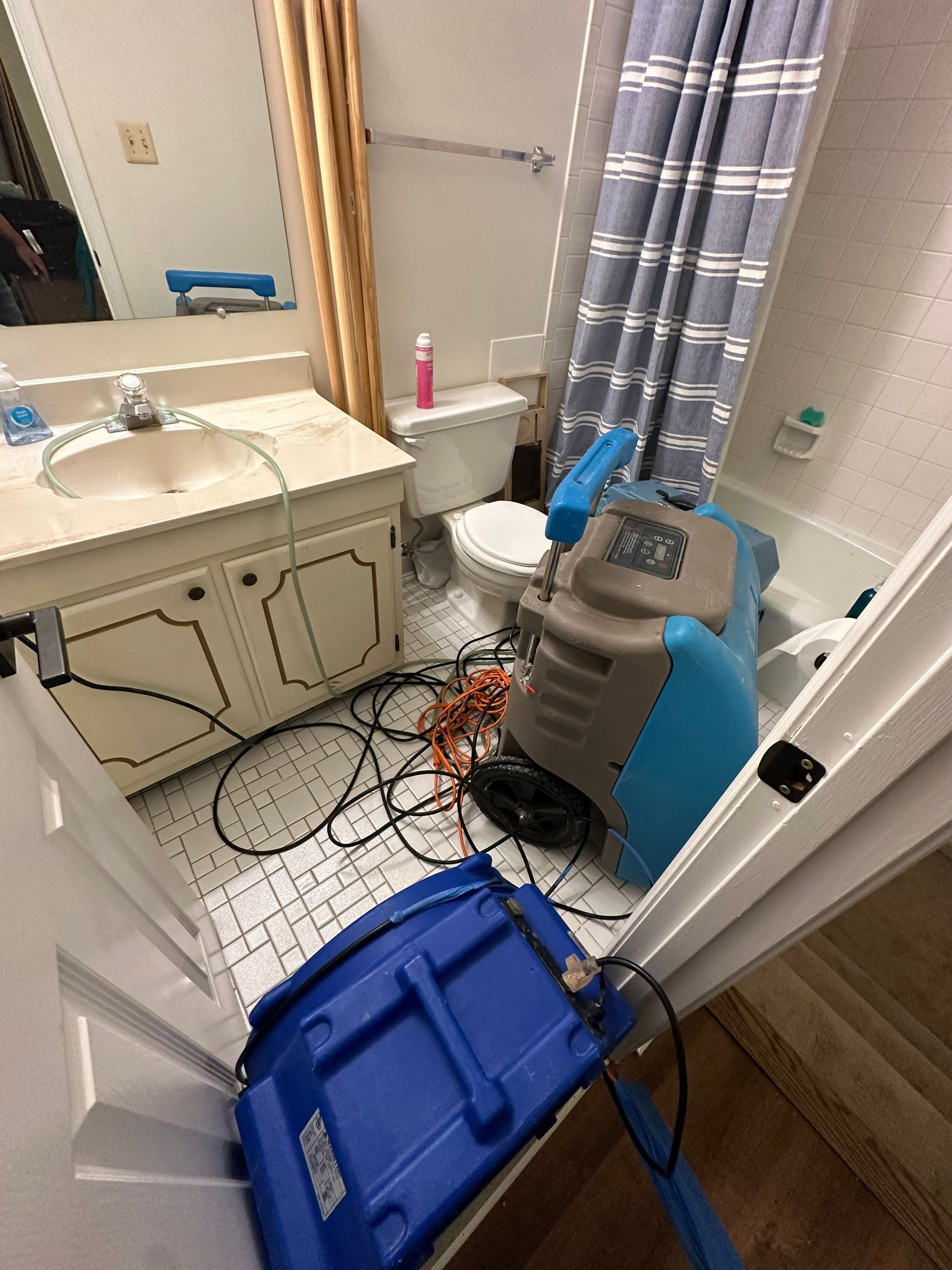 Final-stage water damage restoration in Falls Church showing cleared, dried interior space.