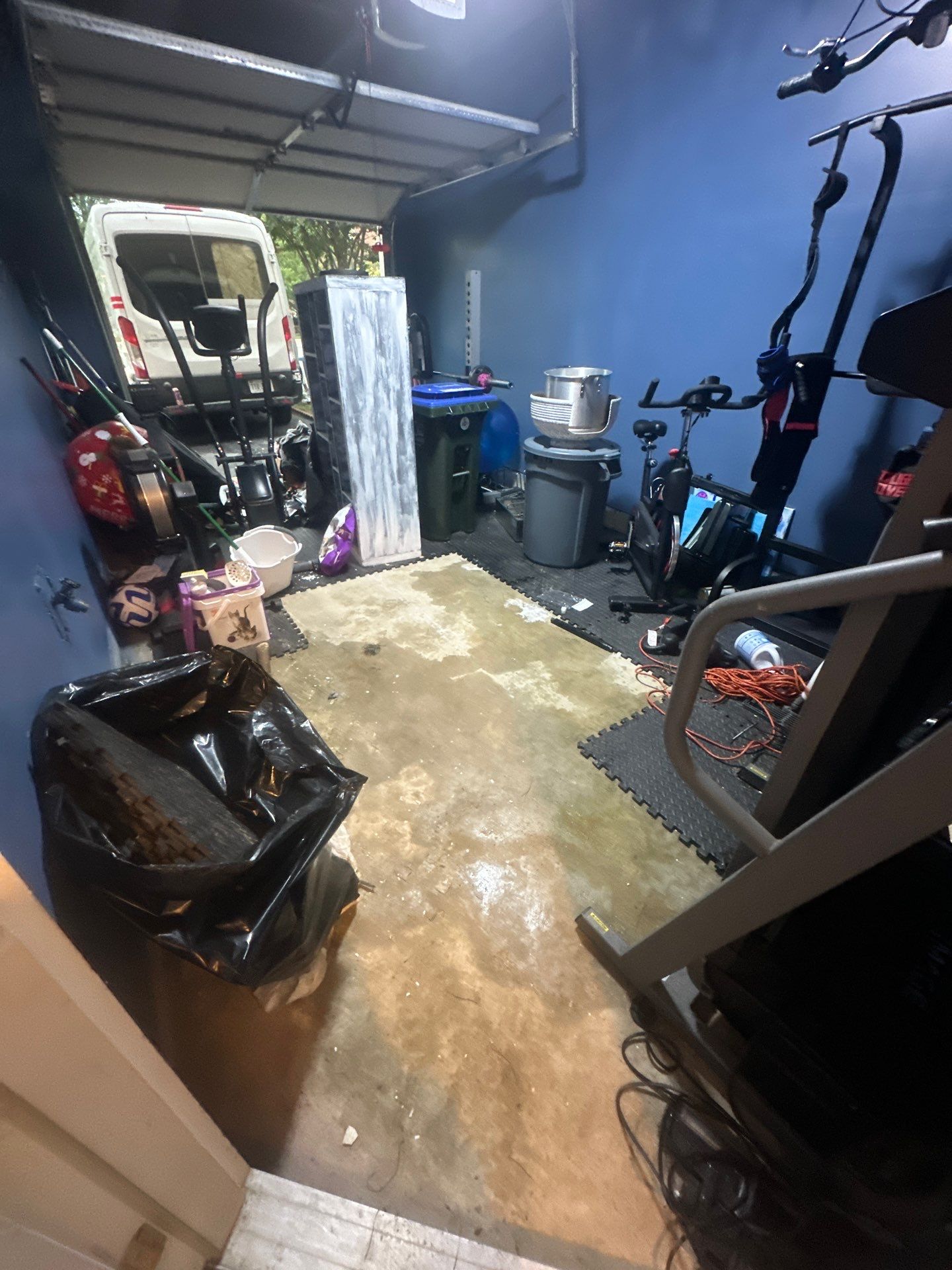 Dehumidification equipment positioned within containment to extract moisture from structural materials in Bristow home.