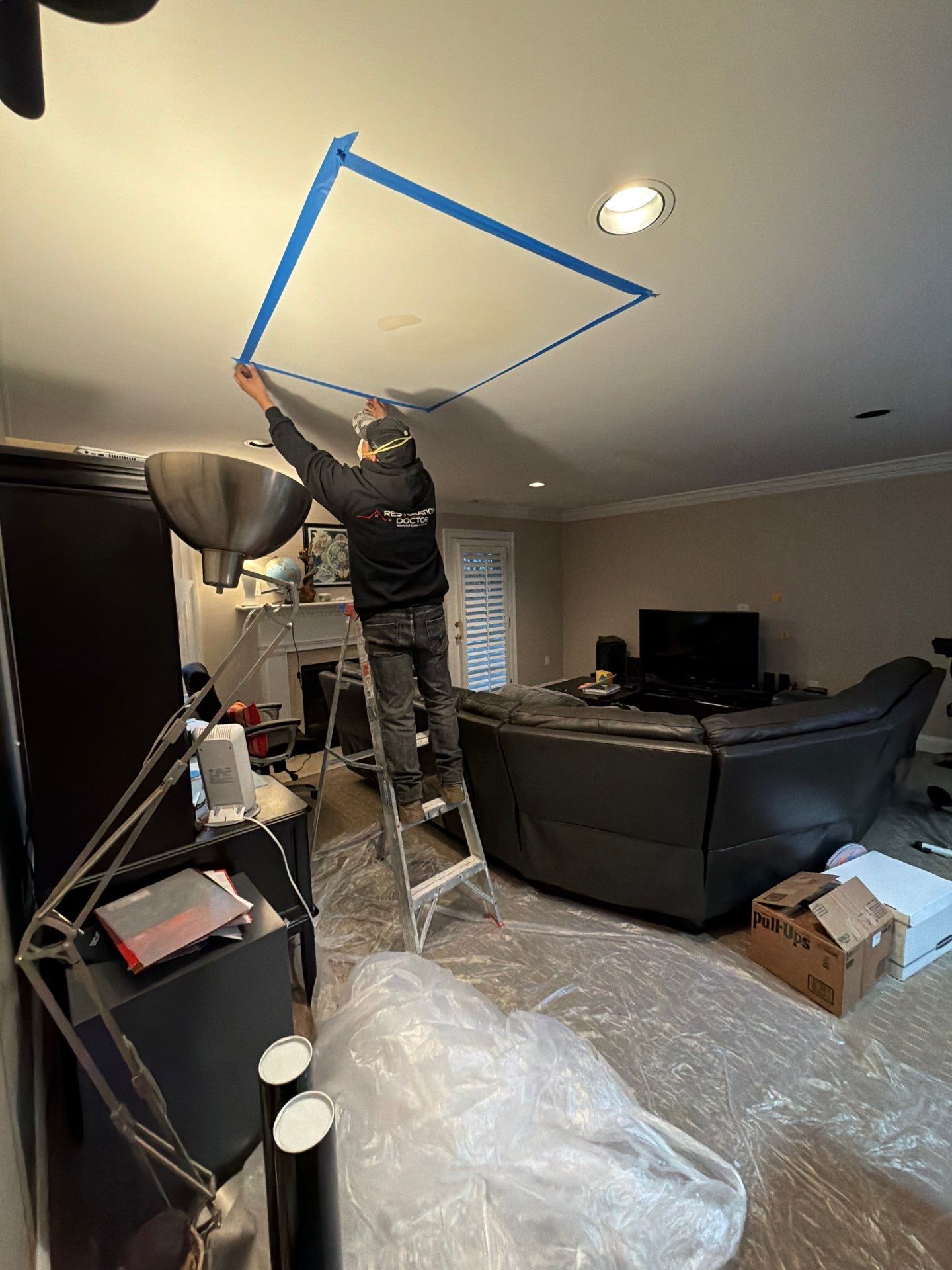 Dehumidification and air circulation equipment positioned within containment to dry structural framing and ceiling cavity.