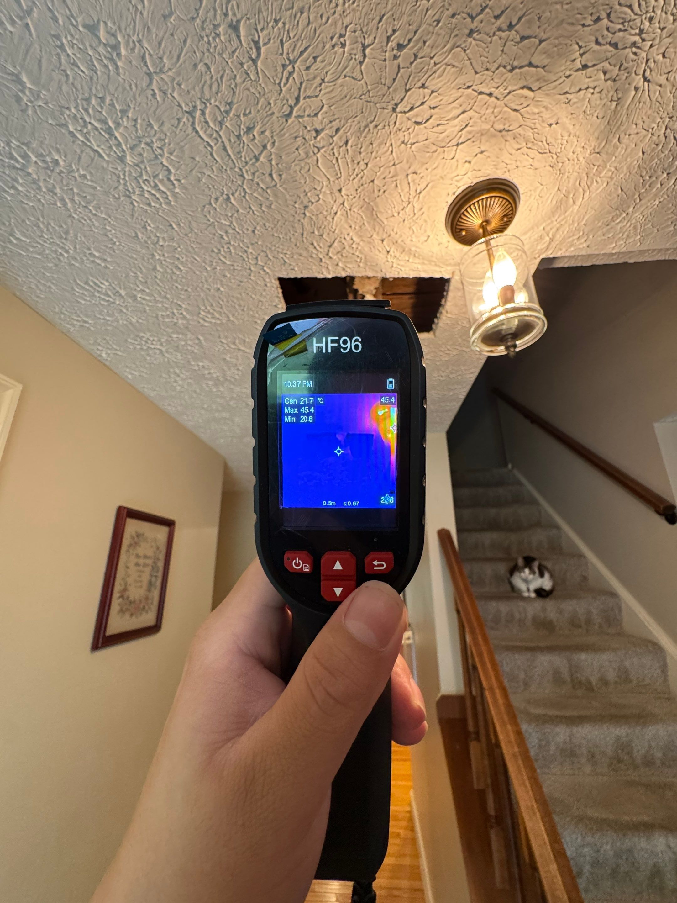 Moisture inspection equipment positioned on ceiling framing to detect hidden water intrusion in restoration work.