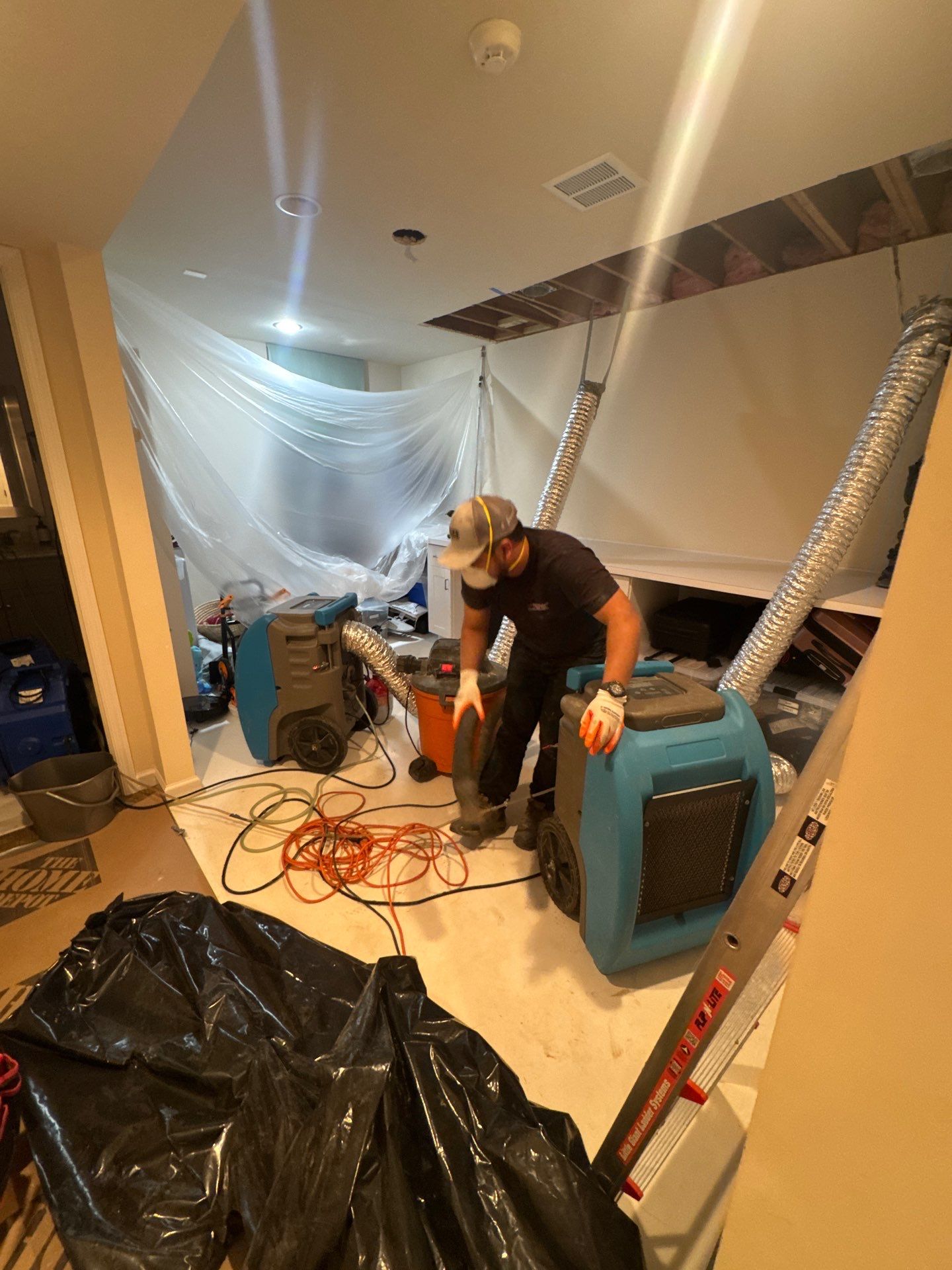 Thermal imaging camera detecting moisture patterns during water damage assessment in Fairfax.