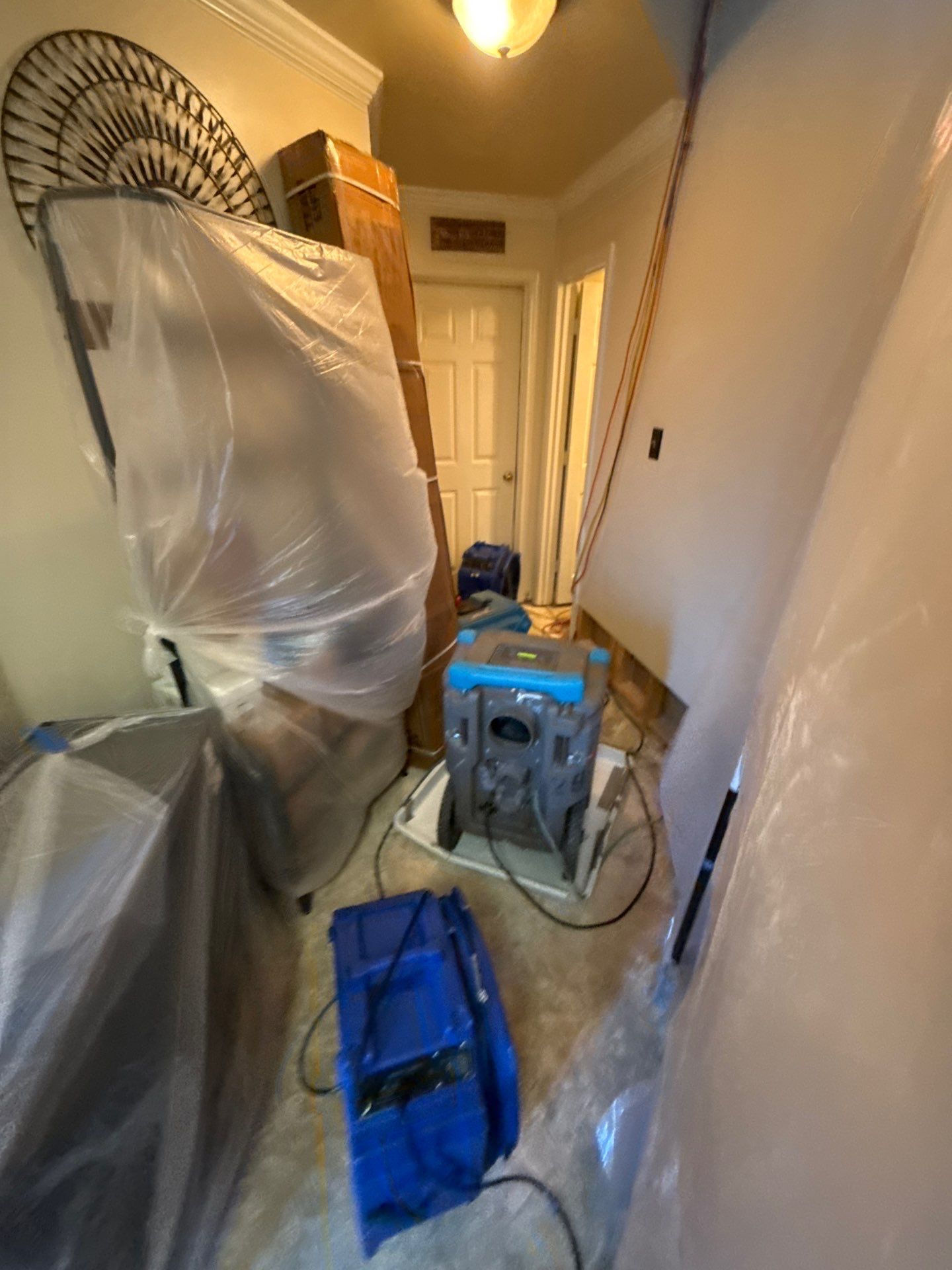 Structural framing exposed after removal of compromised drywall and baseboards in Manassas.