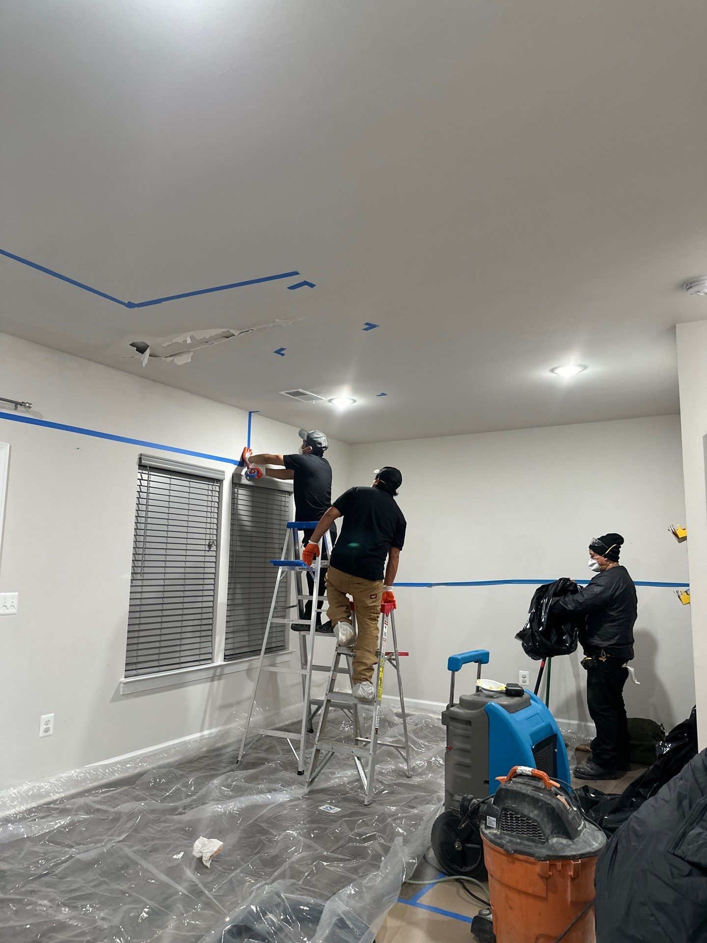Water-damaged ceiling and flooring in Manassas home during initial assessment and structural drying setup.