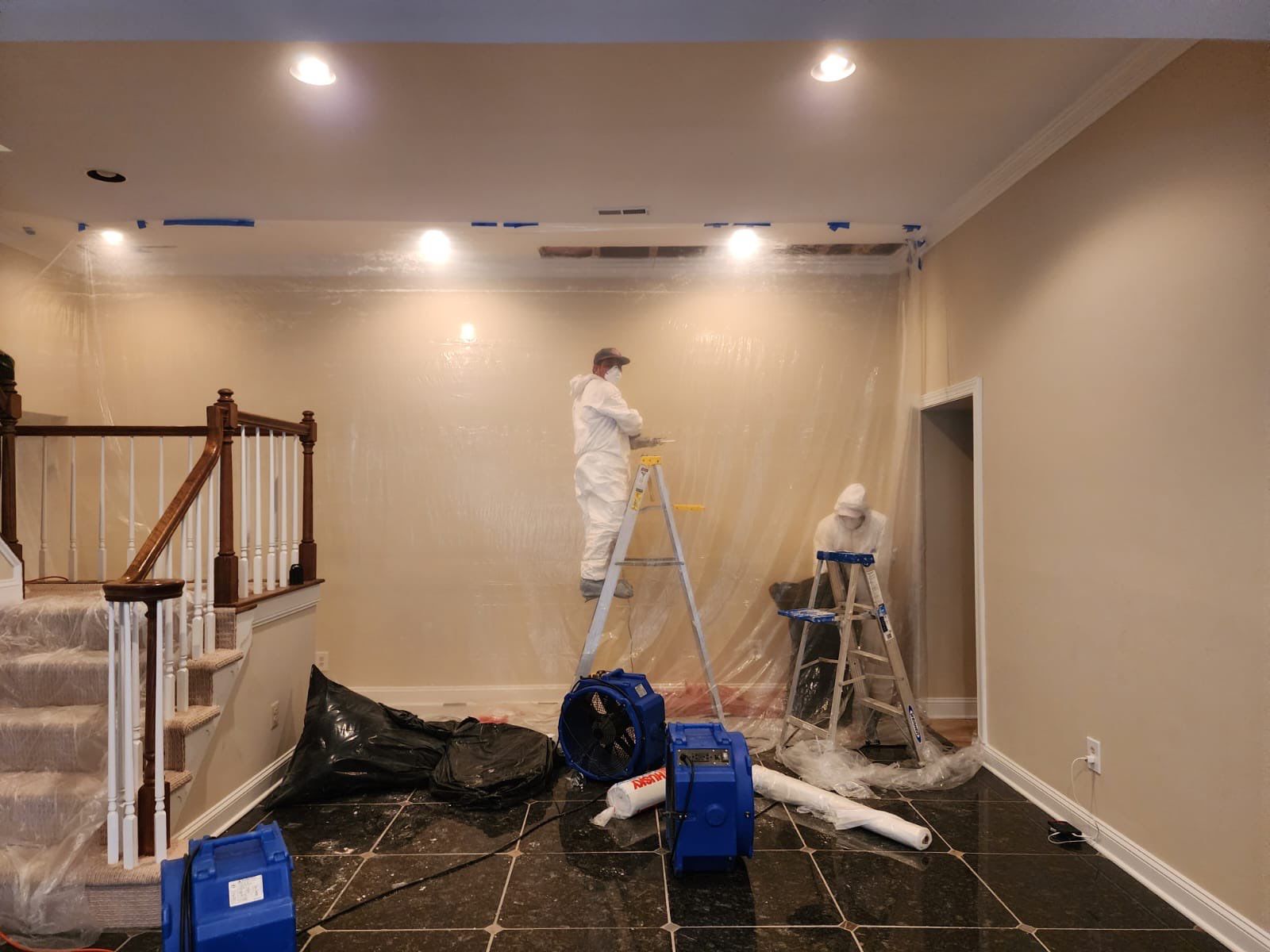 Final-stage water damage restoration in Great Falls with drying equipment removed and ceiling repair completed.