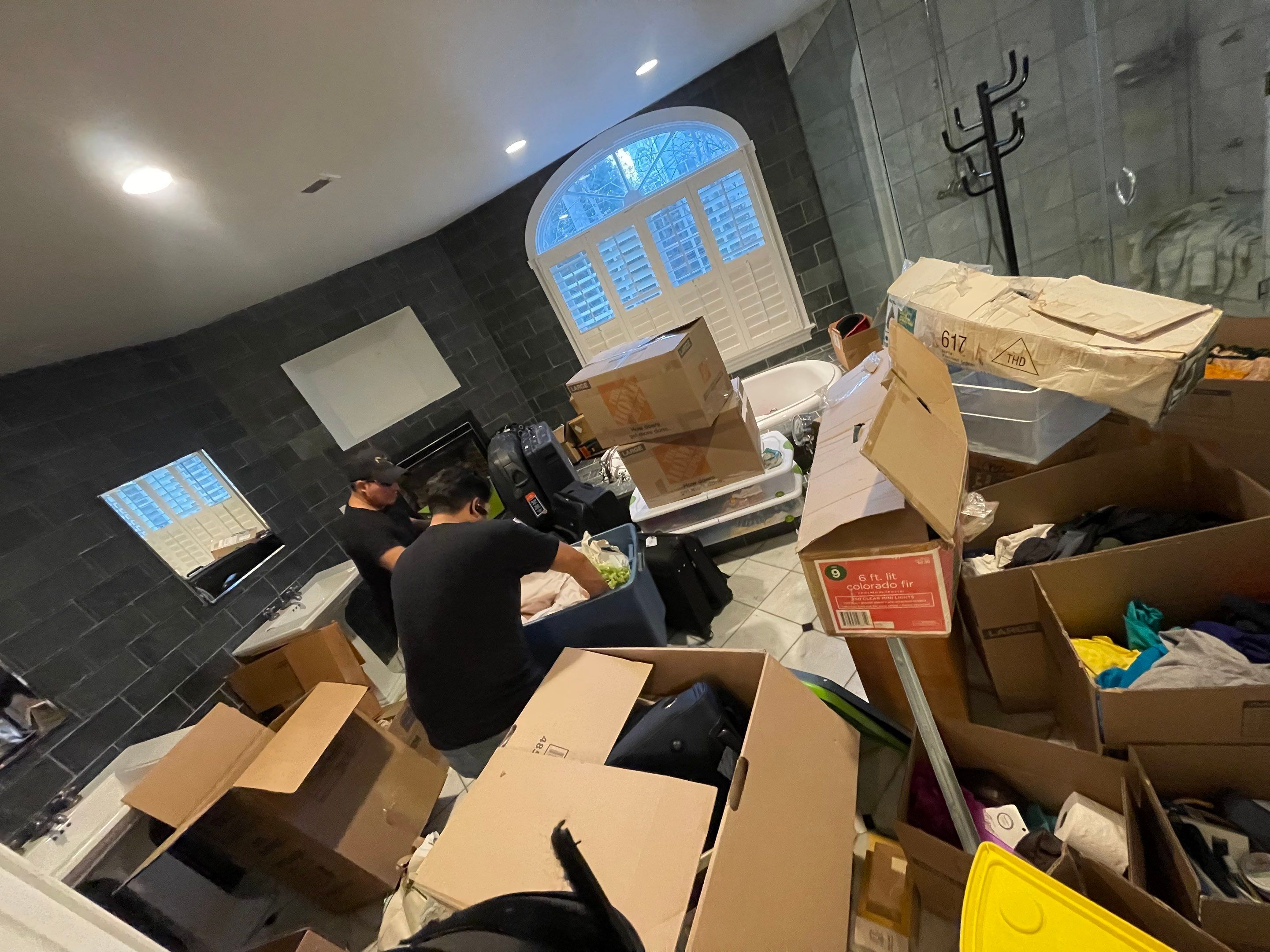 Water damage restoration in Great Falls: dehumidifier and drying equipment positioned in affected room during initial assessment.