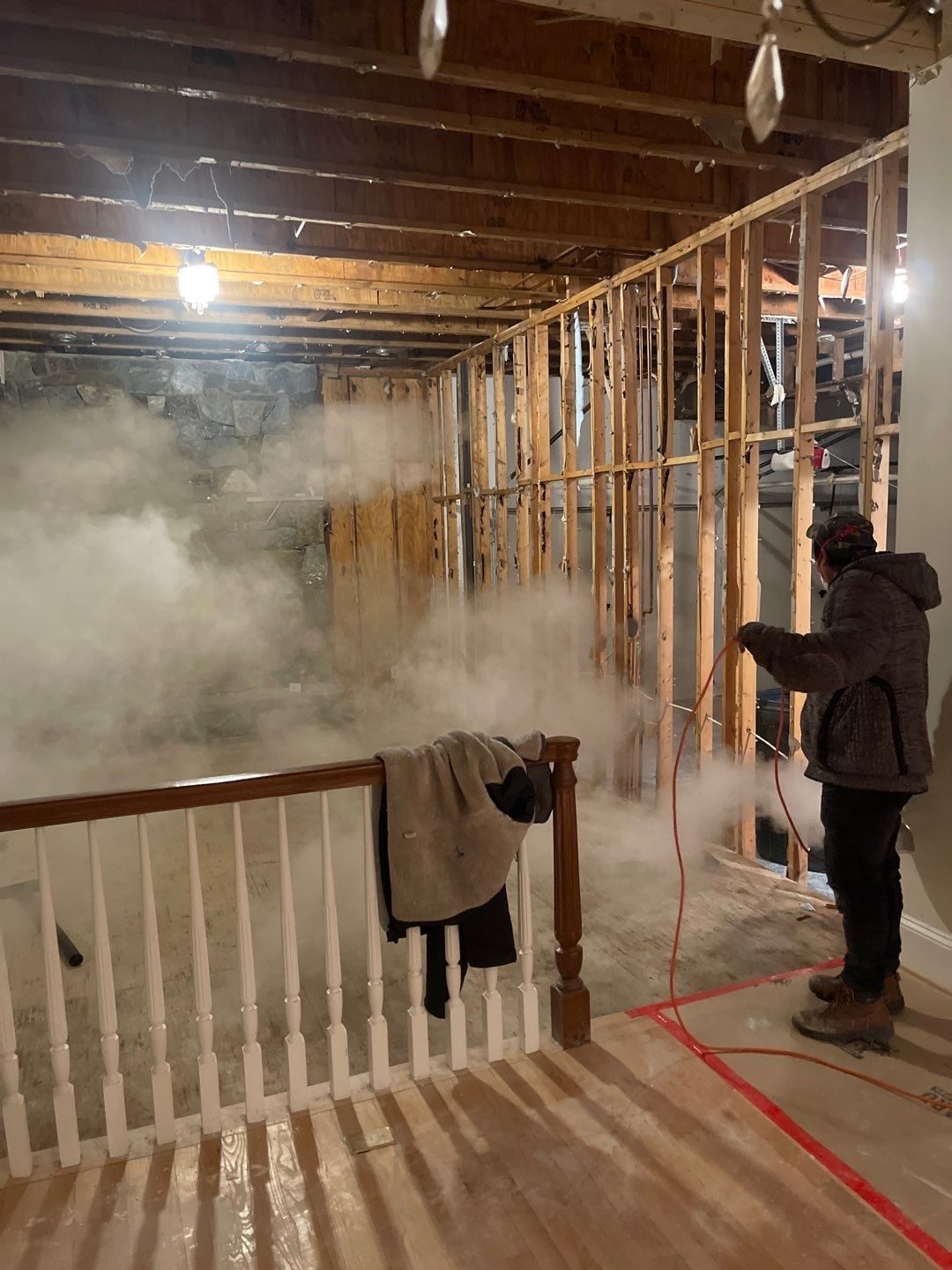 Mid-stage drying showing dehumidifier placement and structural assessment of ceiling repair scope.