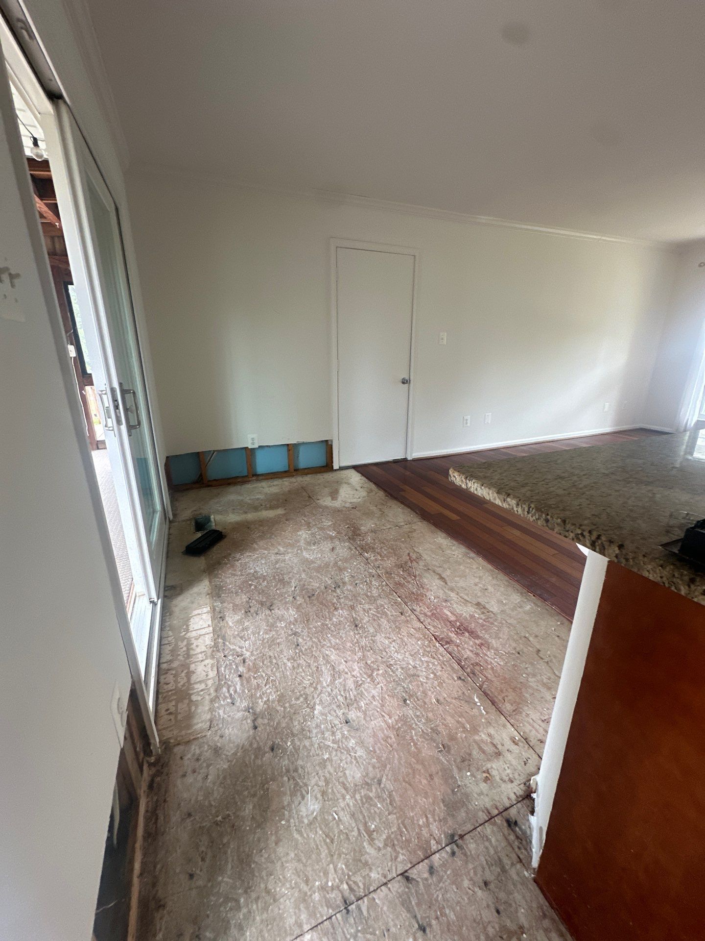 Water-damaged carpet and flooring in Herndon home with dehumidification equipment positioned for structural drying.