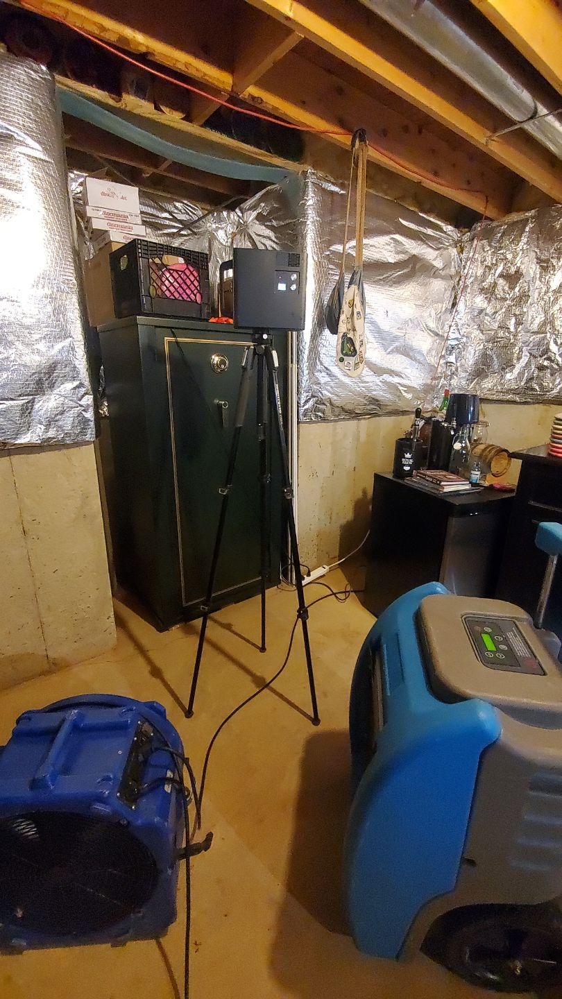 Moisture monitoring equipment positioned throughout affected areas during active drying phase of water restoration.