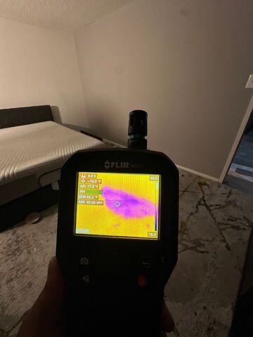 Thermal imaging reveals moisture distribution across wall cavity during Alexandria water damage assessment.