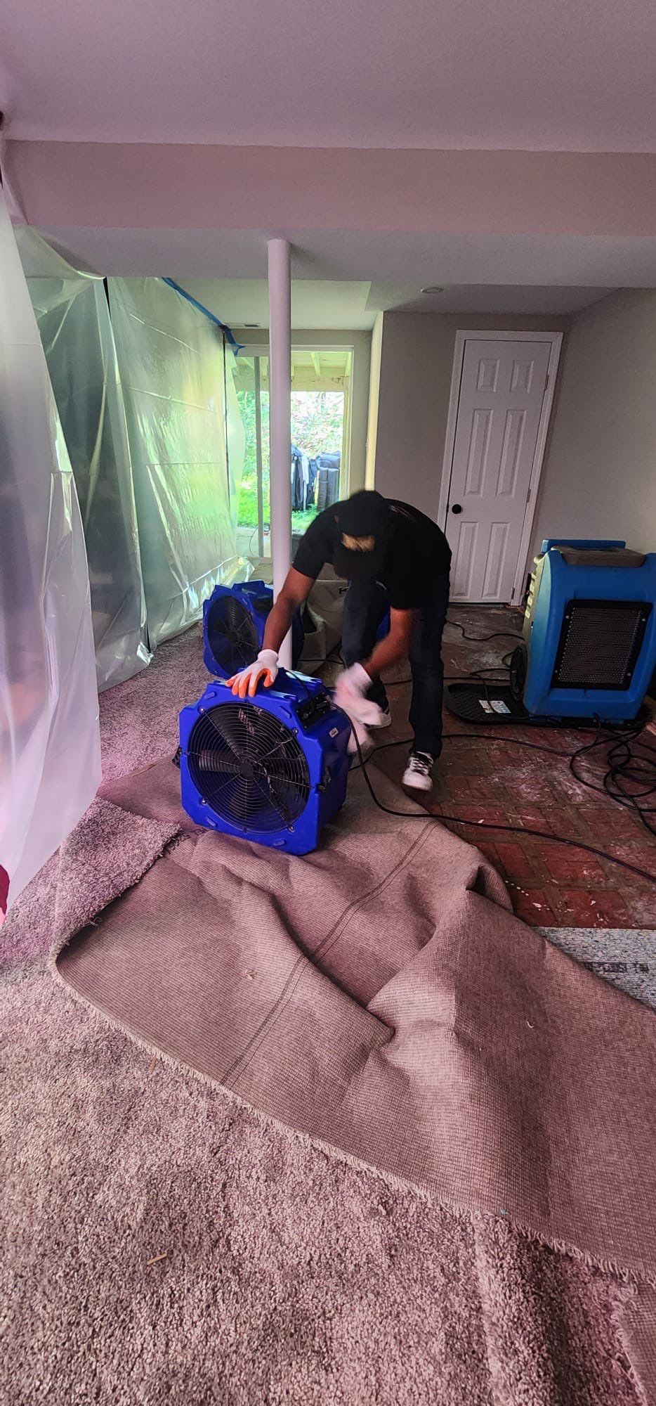 Containment barrier and dehumidifier set up during water damage restoration in Woodbridge.