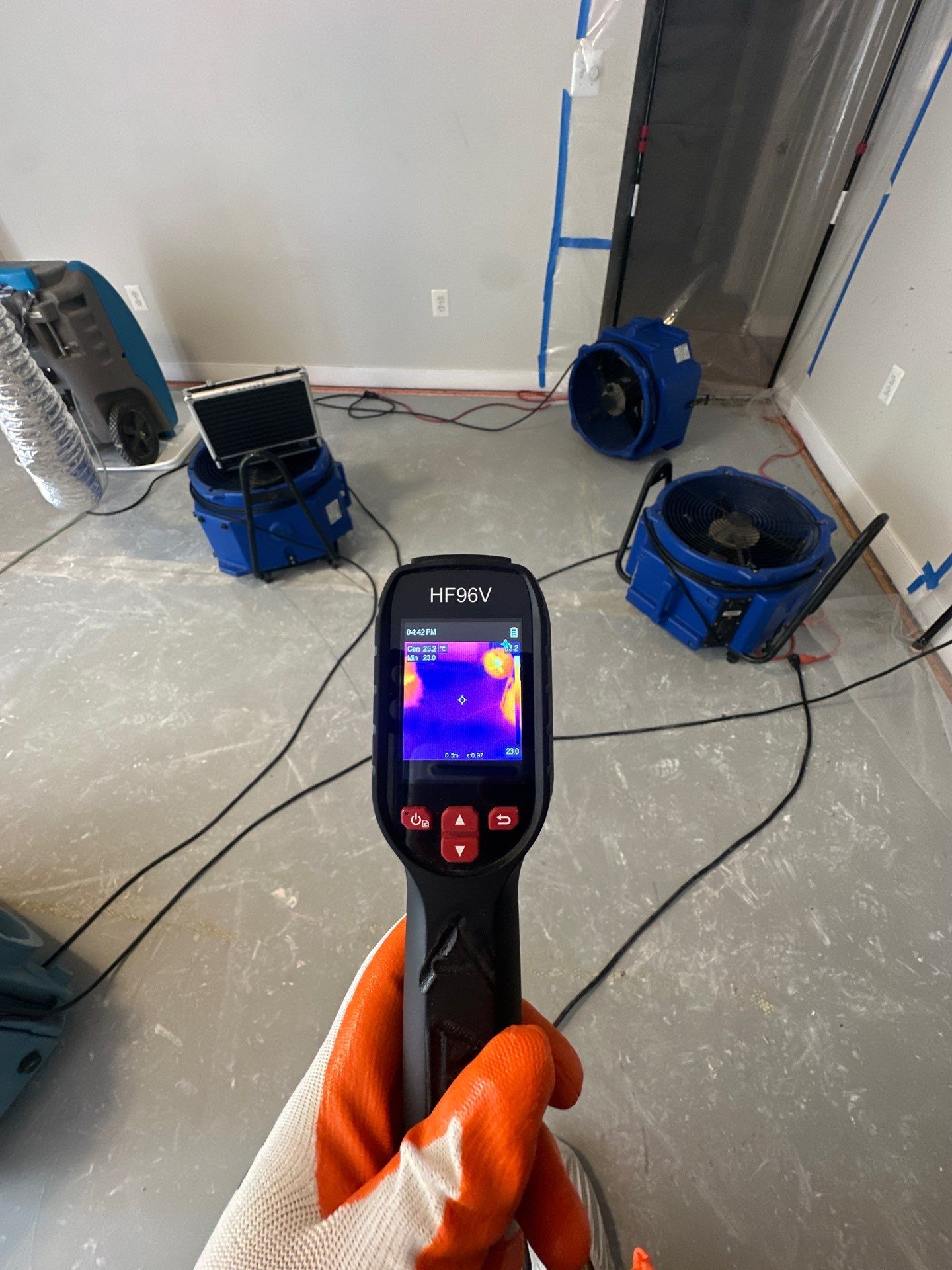 Structural drying equipment positioned to address moisture in affected ceiling cavity.