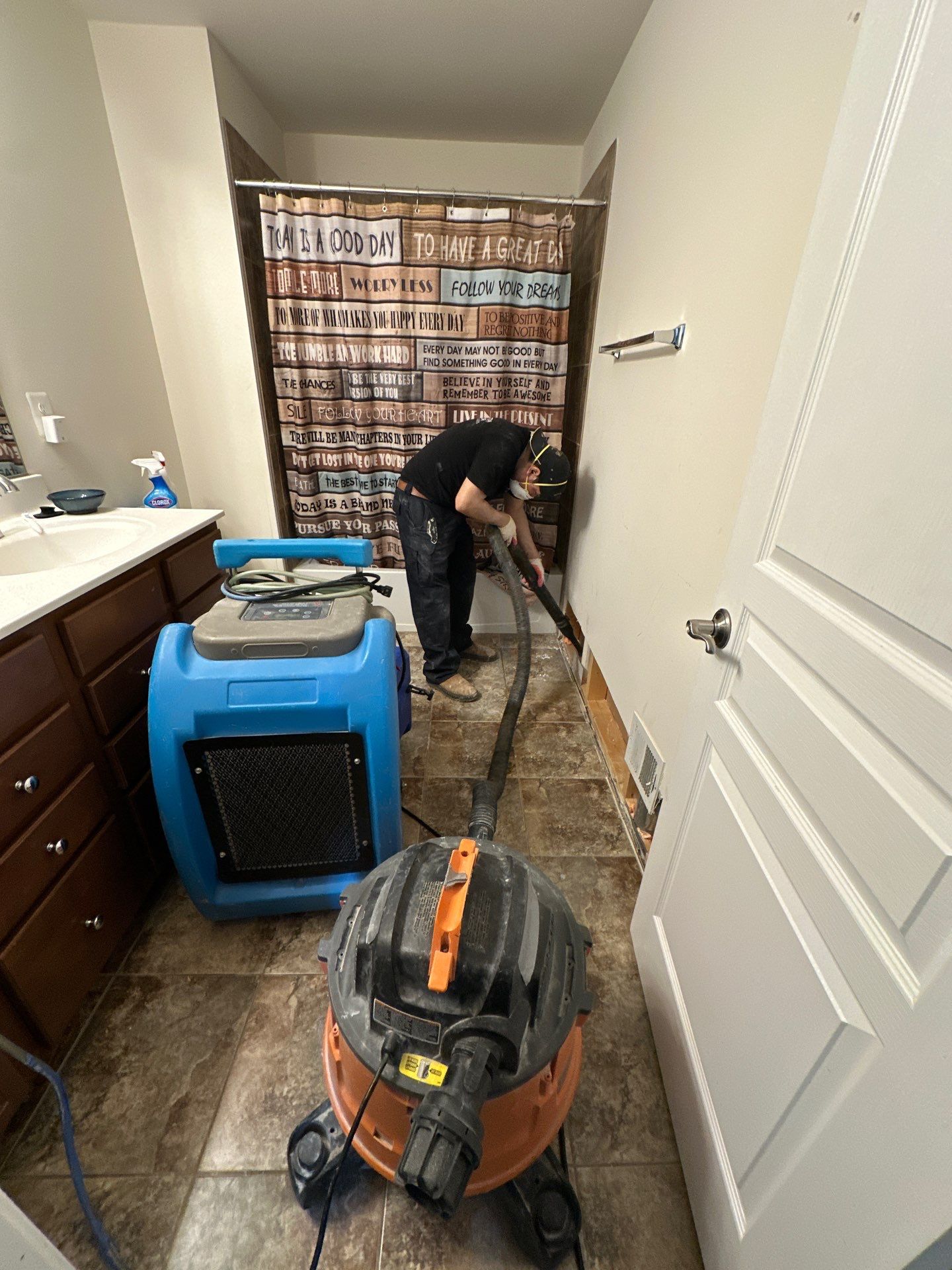 Ceiling cavity exposed during water damage restoration, monitoring drying progress in Alexandria residential space.