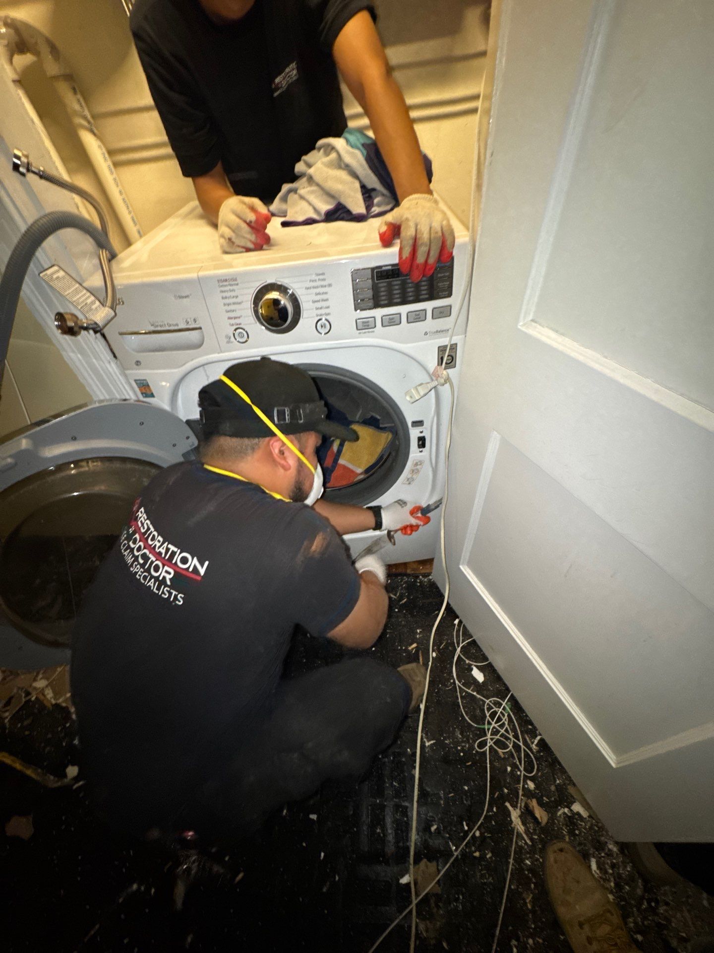 Extraction equipment removing standing water from affected interior space as part of Arlington water damage restoration.