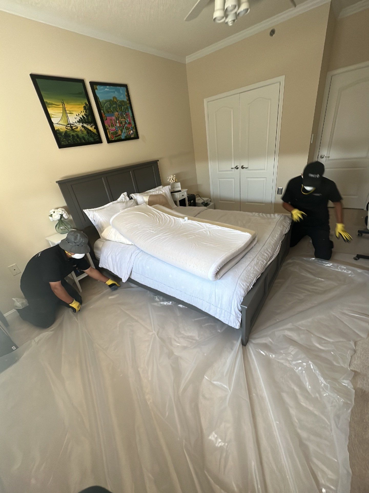 Drying equipment positioned to extract residual moisture from structural framing and ceiling assembly.