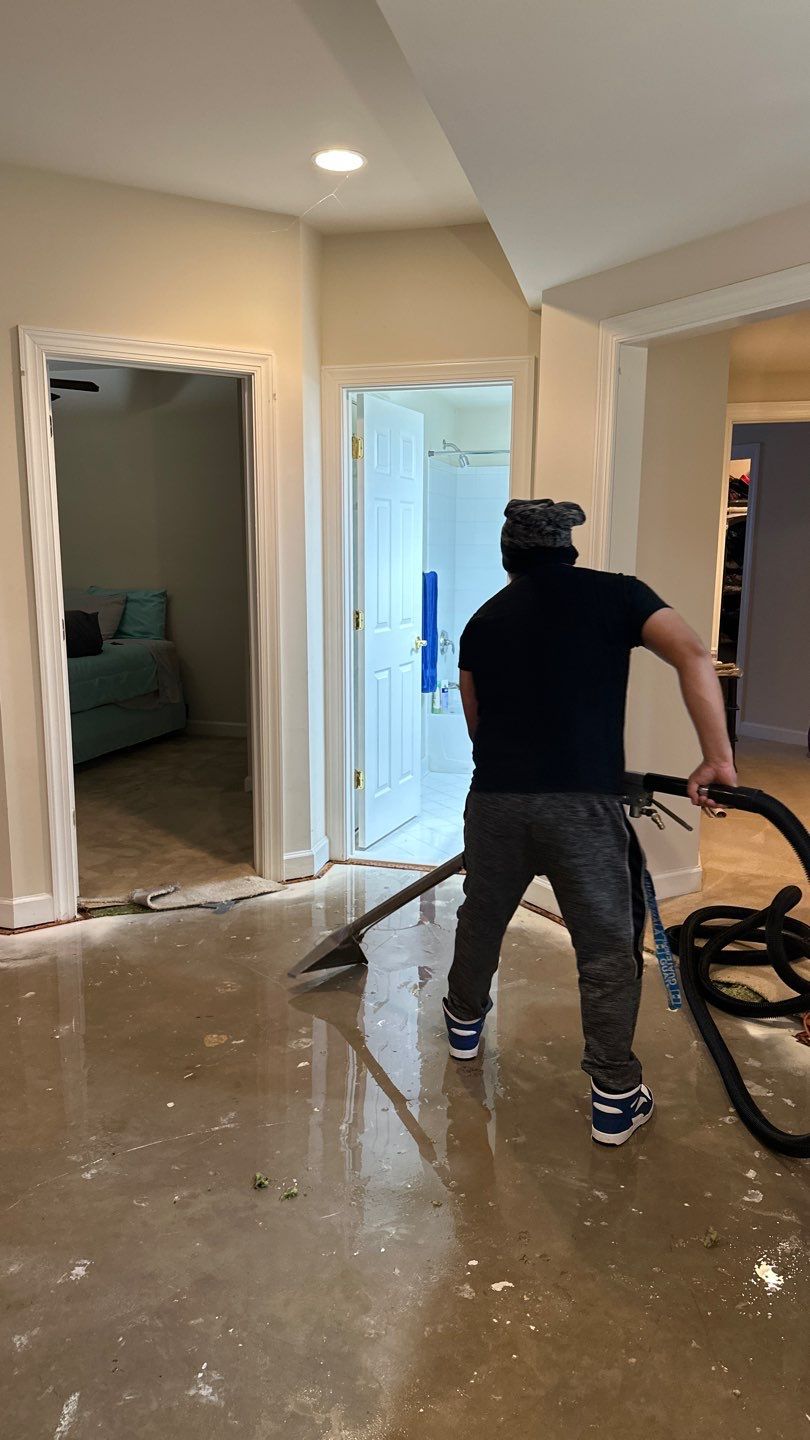 Standing water extraction underway in Leesburg water damage restoration, initial assessment phase.