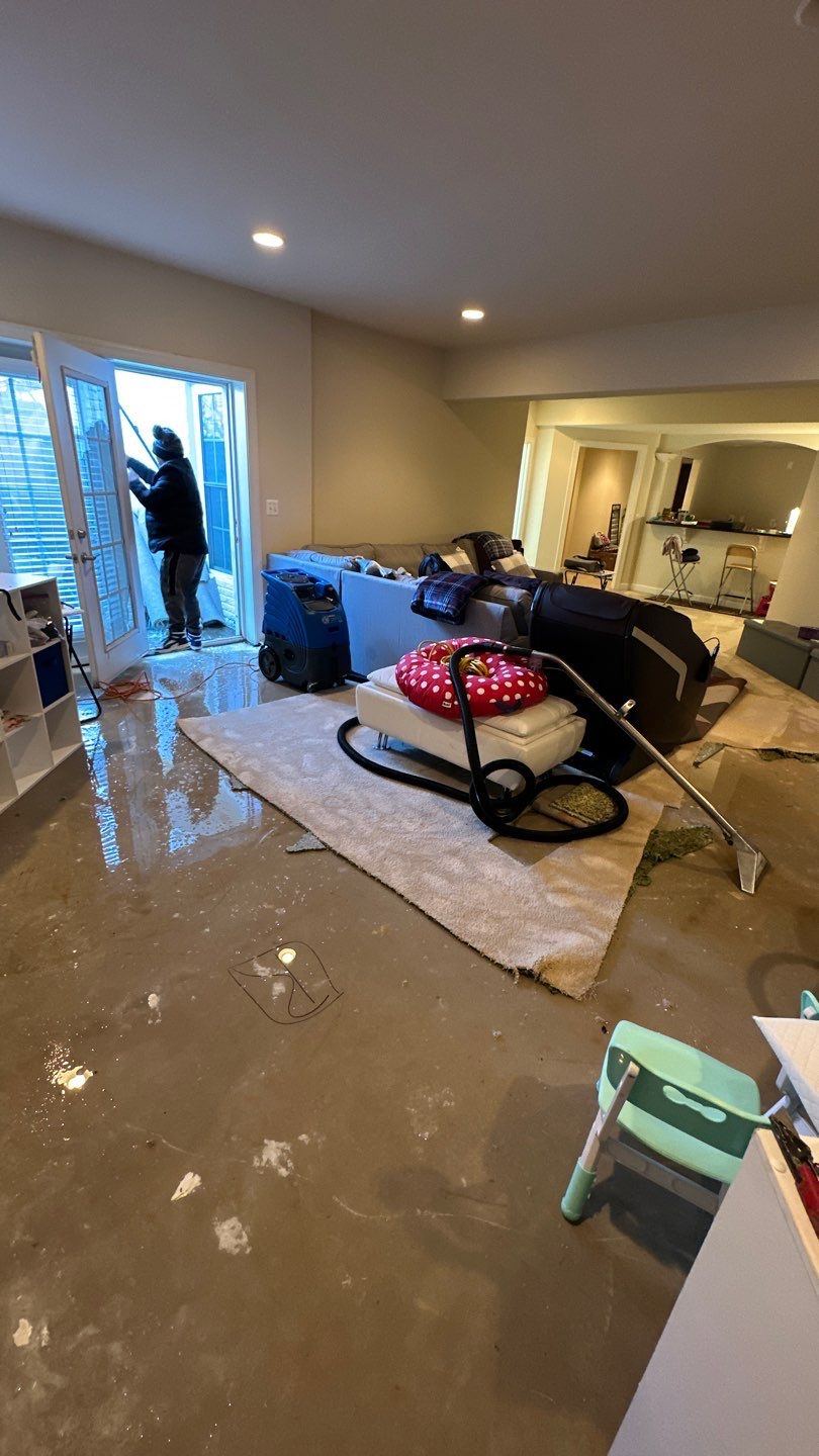 Dehumidification equipment positioned during mid-stage drying of water-damaged structure.