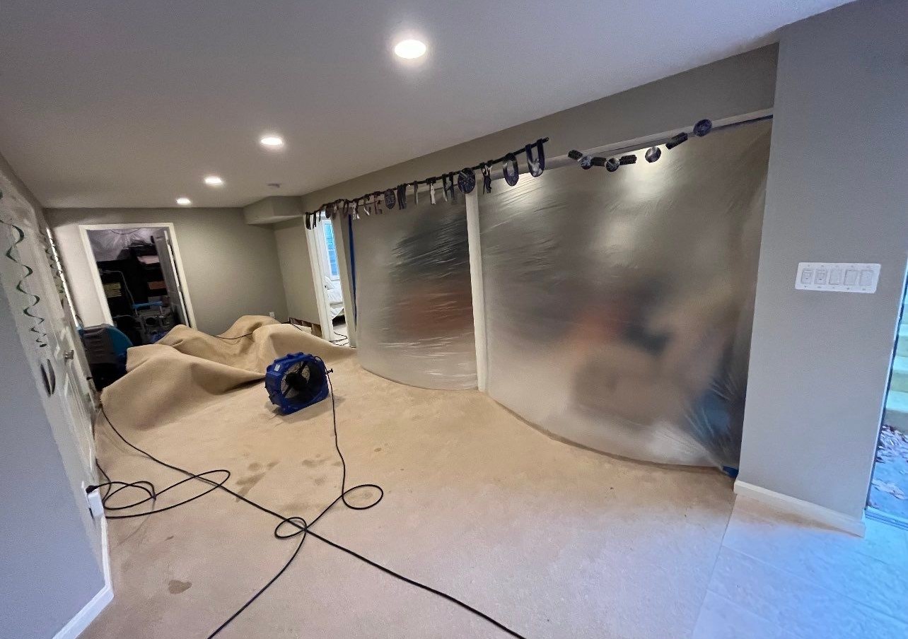 Dehumidifiers and air movers positioned throughout affected areas during structural drying phase.
