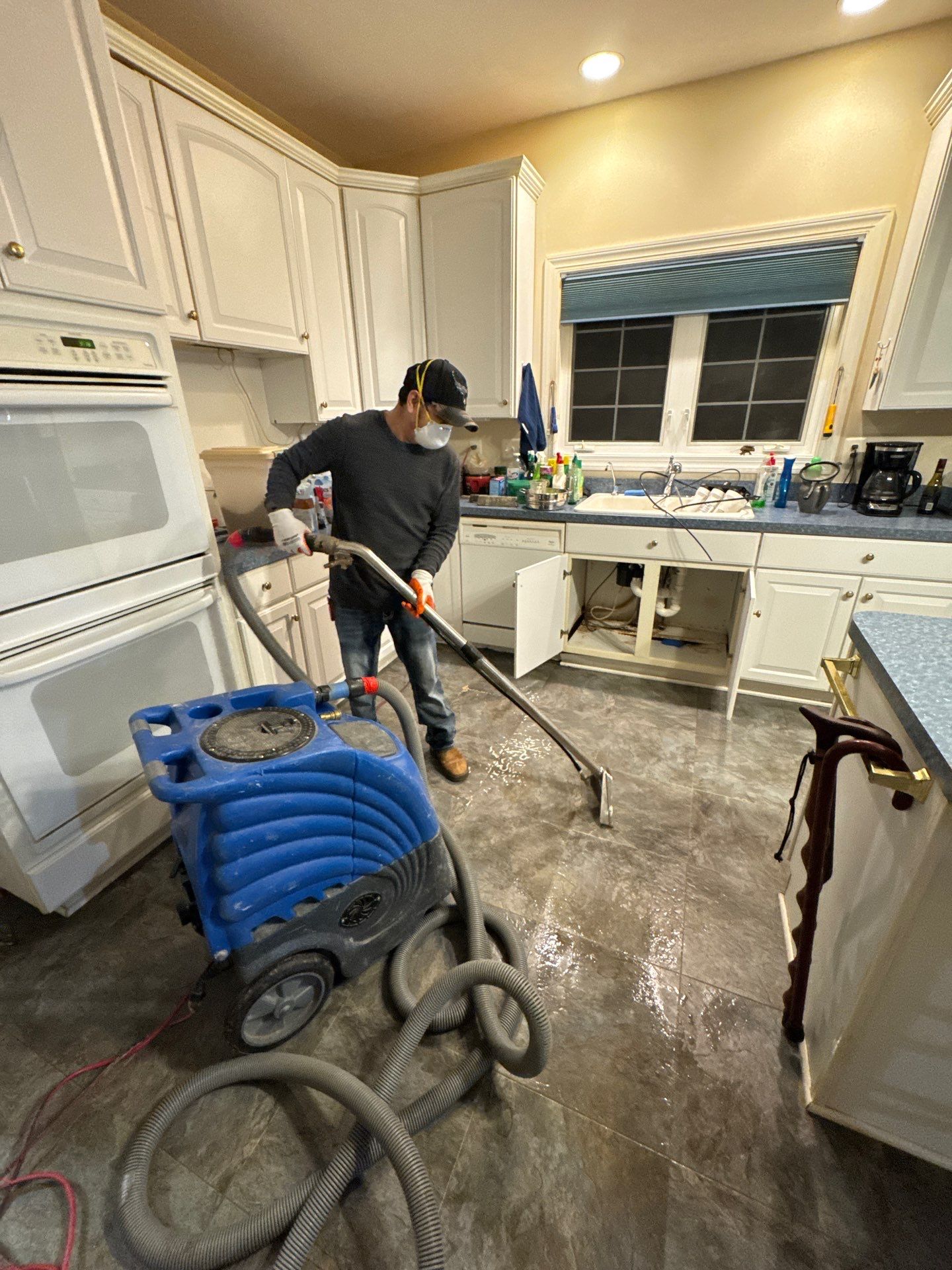 Structural drying phase with dehumidifiers and air movers positioned to manage moisture in wall cavities.