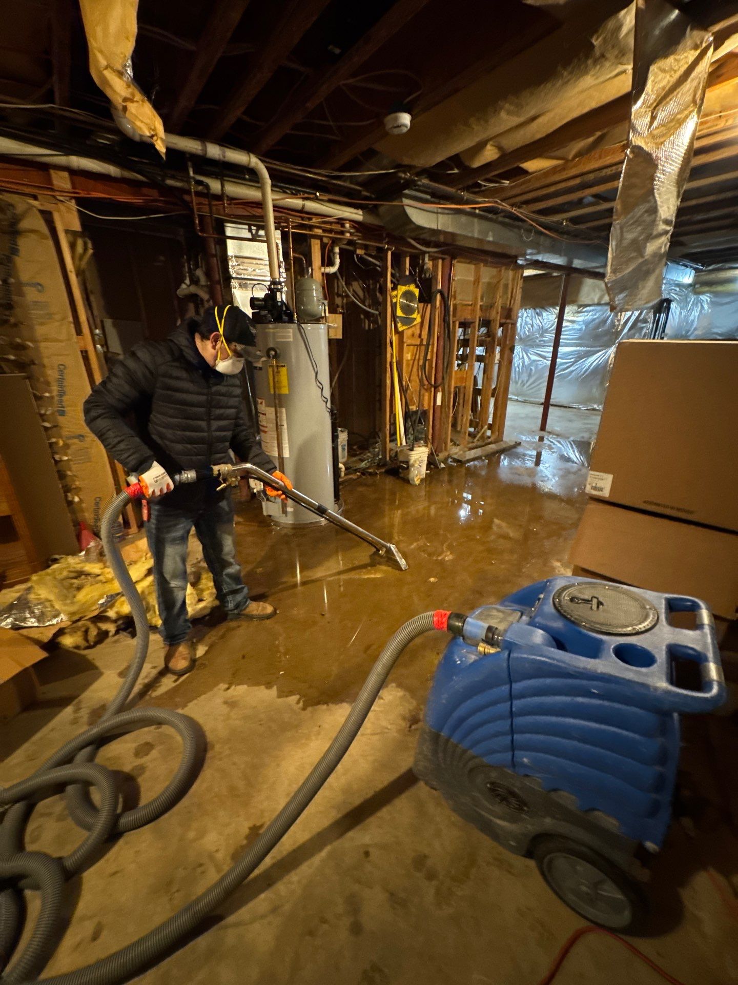 Standing water removal underway in Warrenton mold remediation, extractors deployed across affected floor.