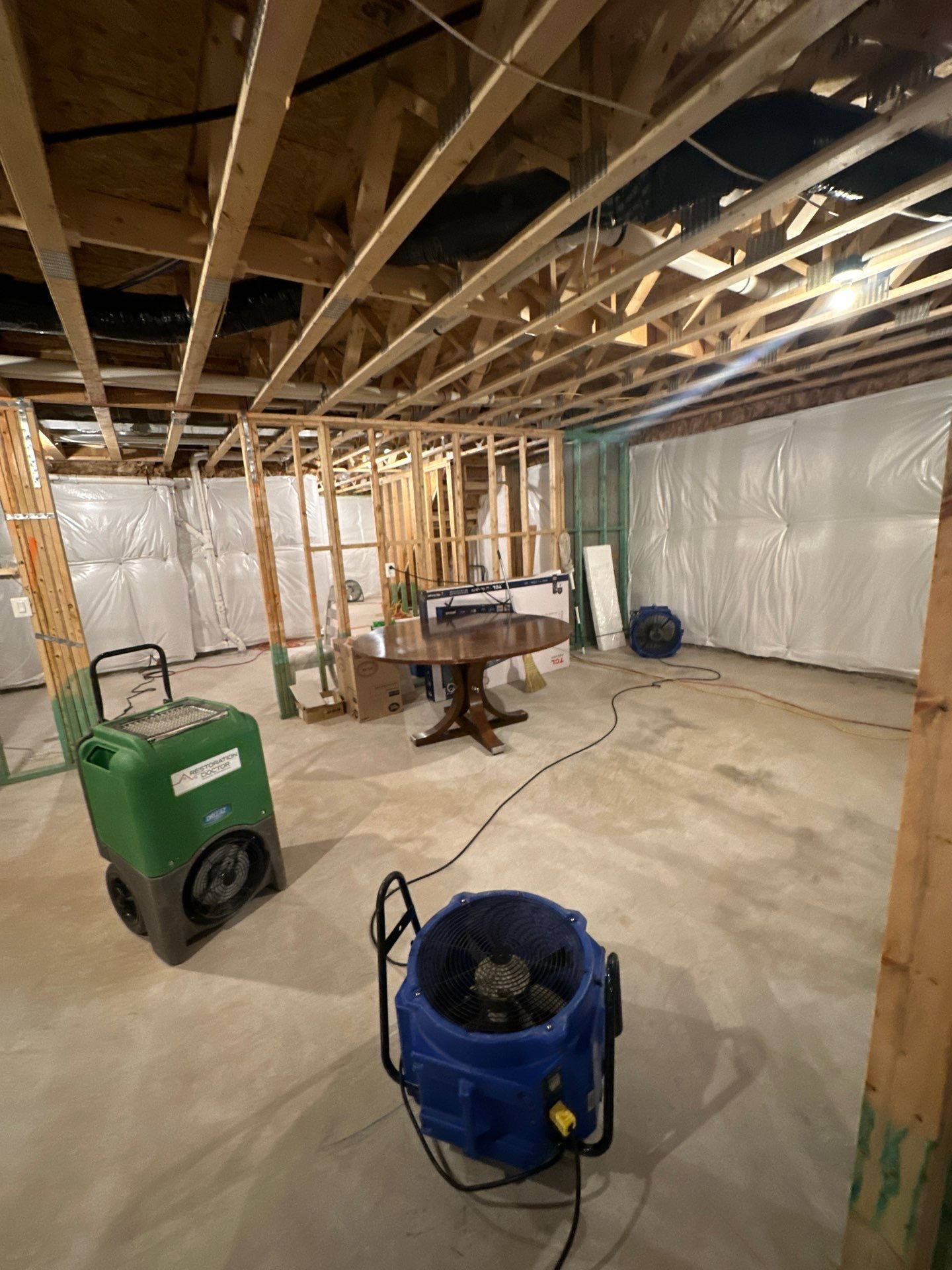 Structural drying equipment positioned to address moisture intrusion identified in initial assessment.