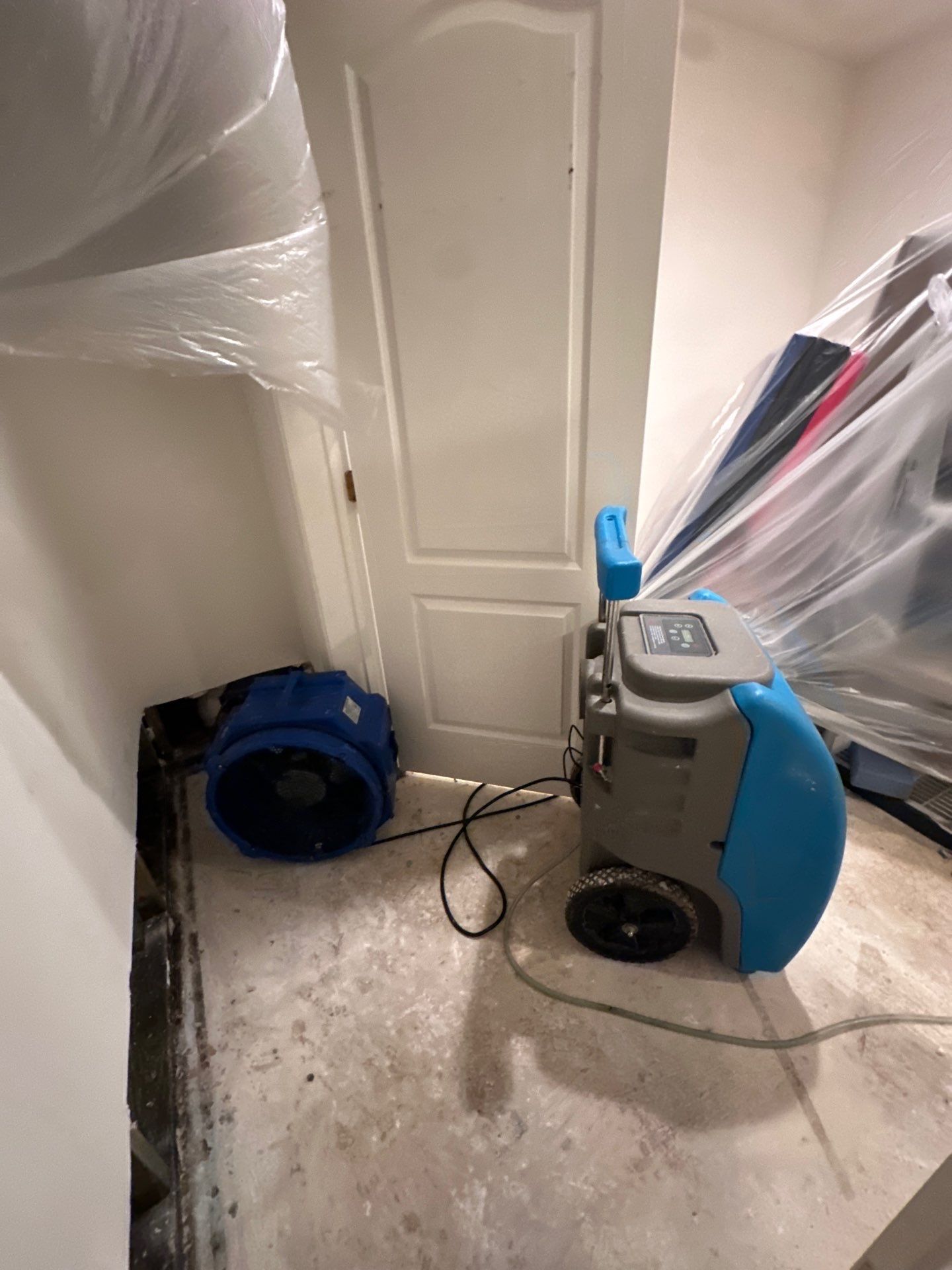 Dehumidification equipment positioned for structural drying phase of water restoration work.