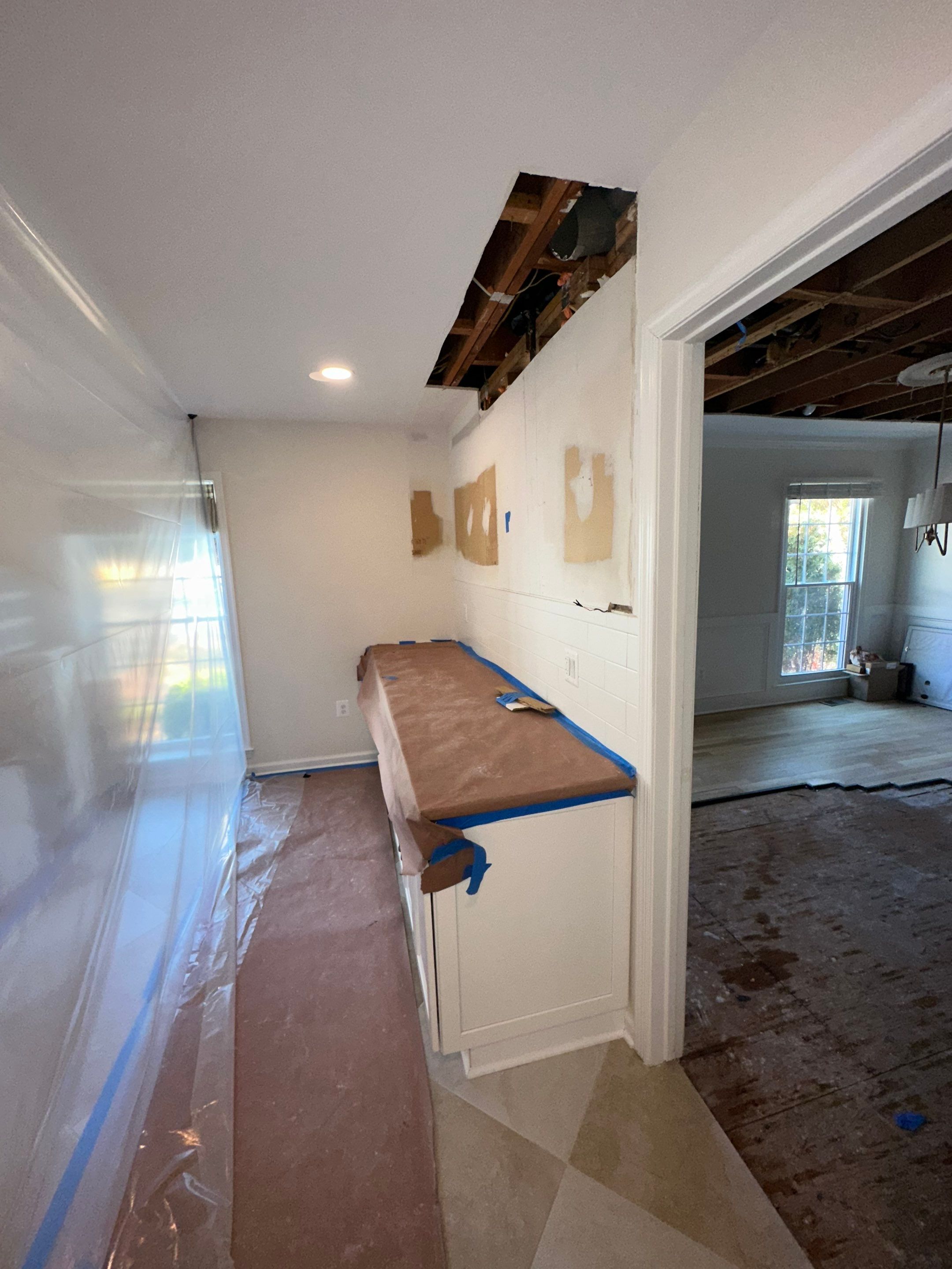 Wall cavity exposure and moisture assessment in Vienna water restoration project.
