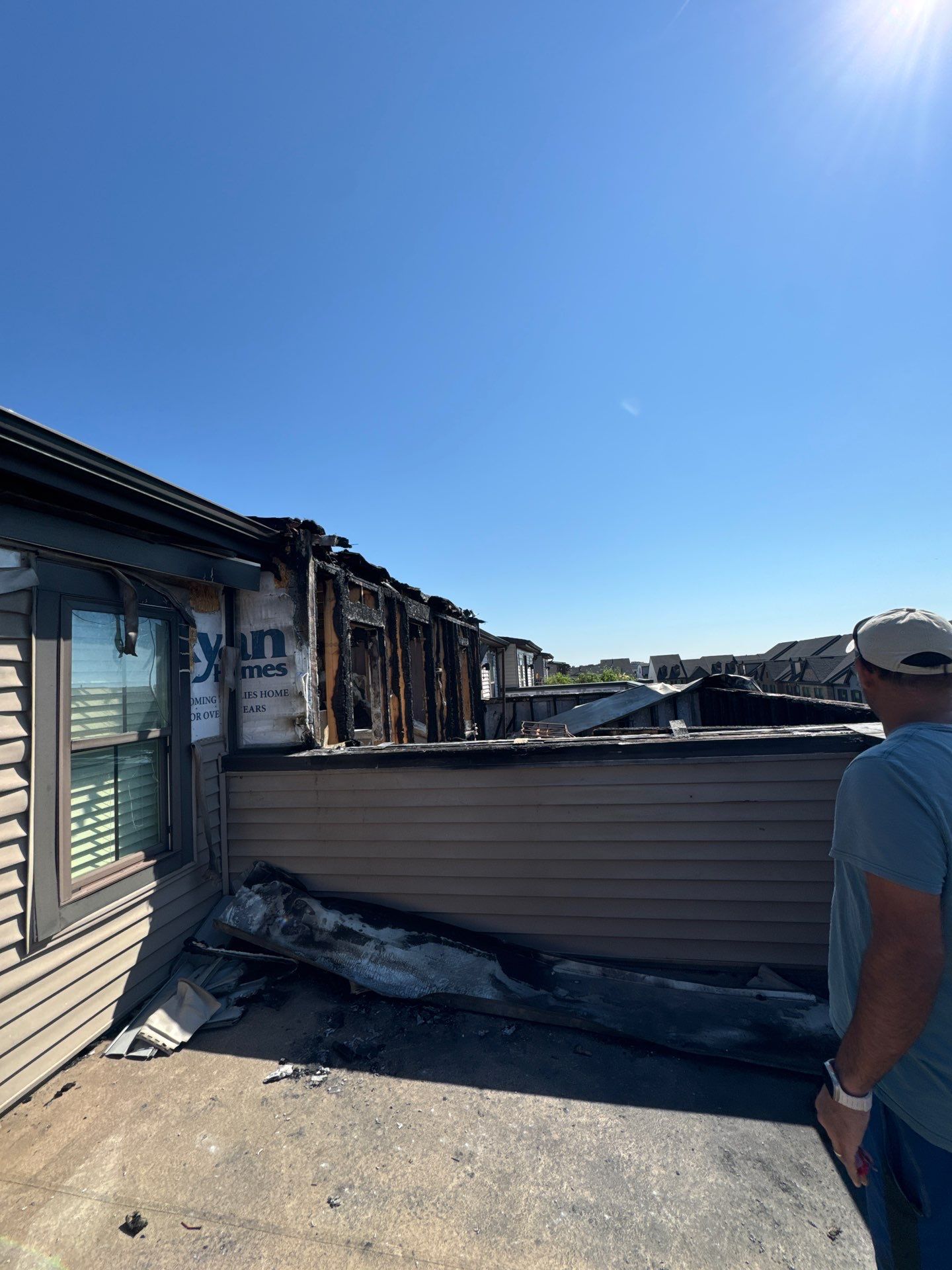 Fire damage assessment in Ashburn showing structural damage from neighboring property fire.