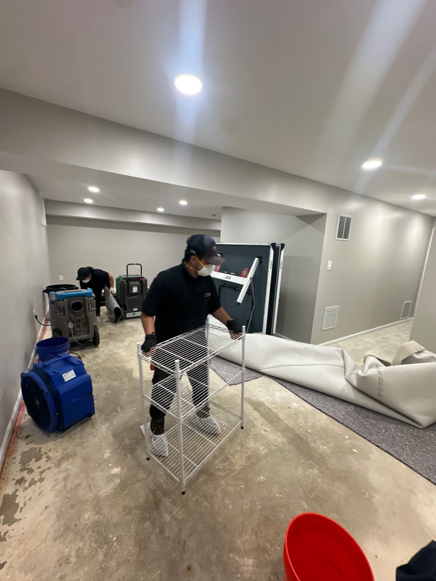Flooring stripped and drying in progress; baseboards staged for replacement in Chantilly water restoration.