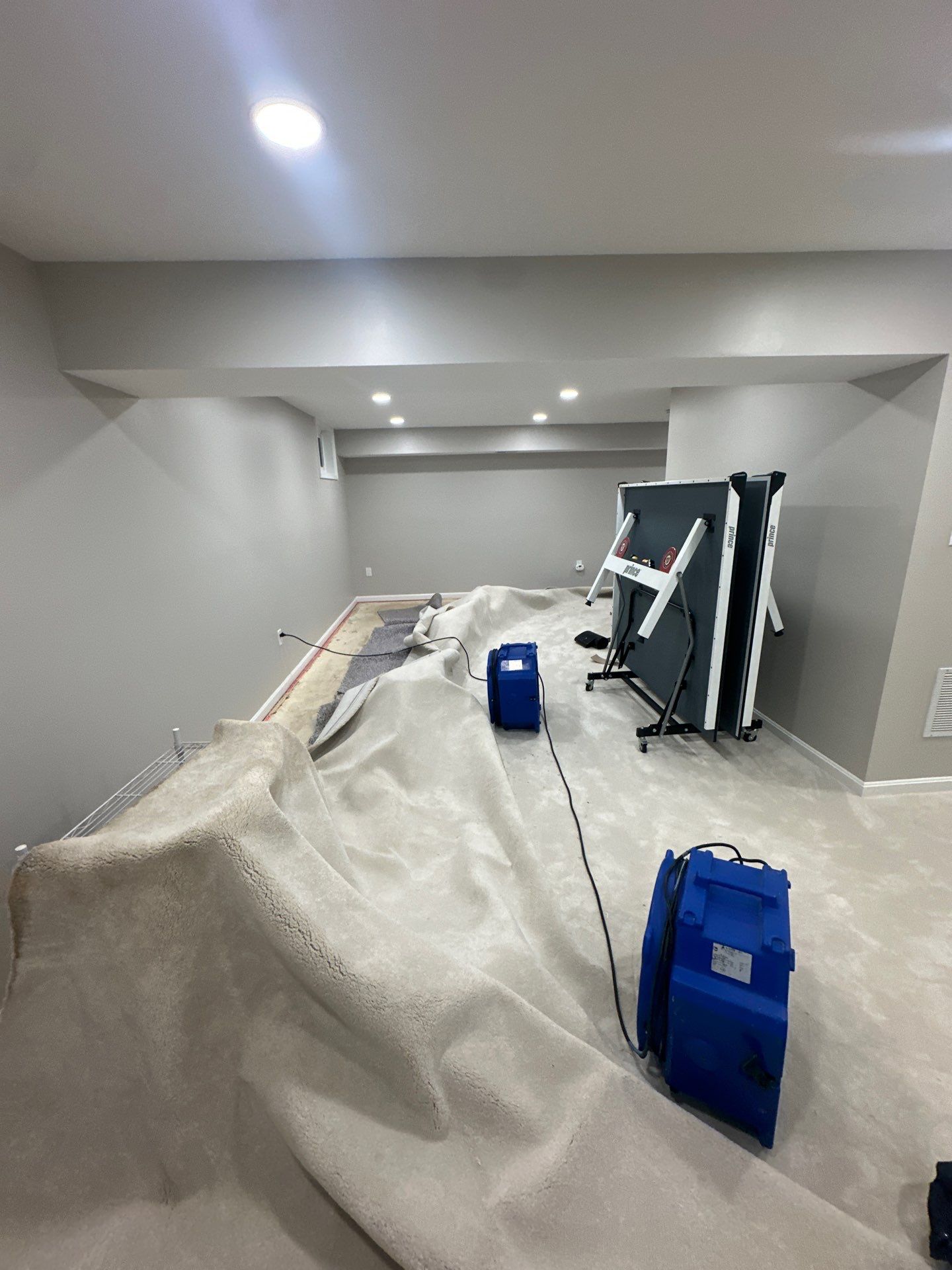 Dehumidification units positioned throughout affected room during water damage restoration in Chantilly.
