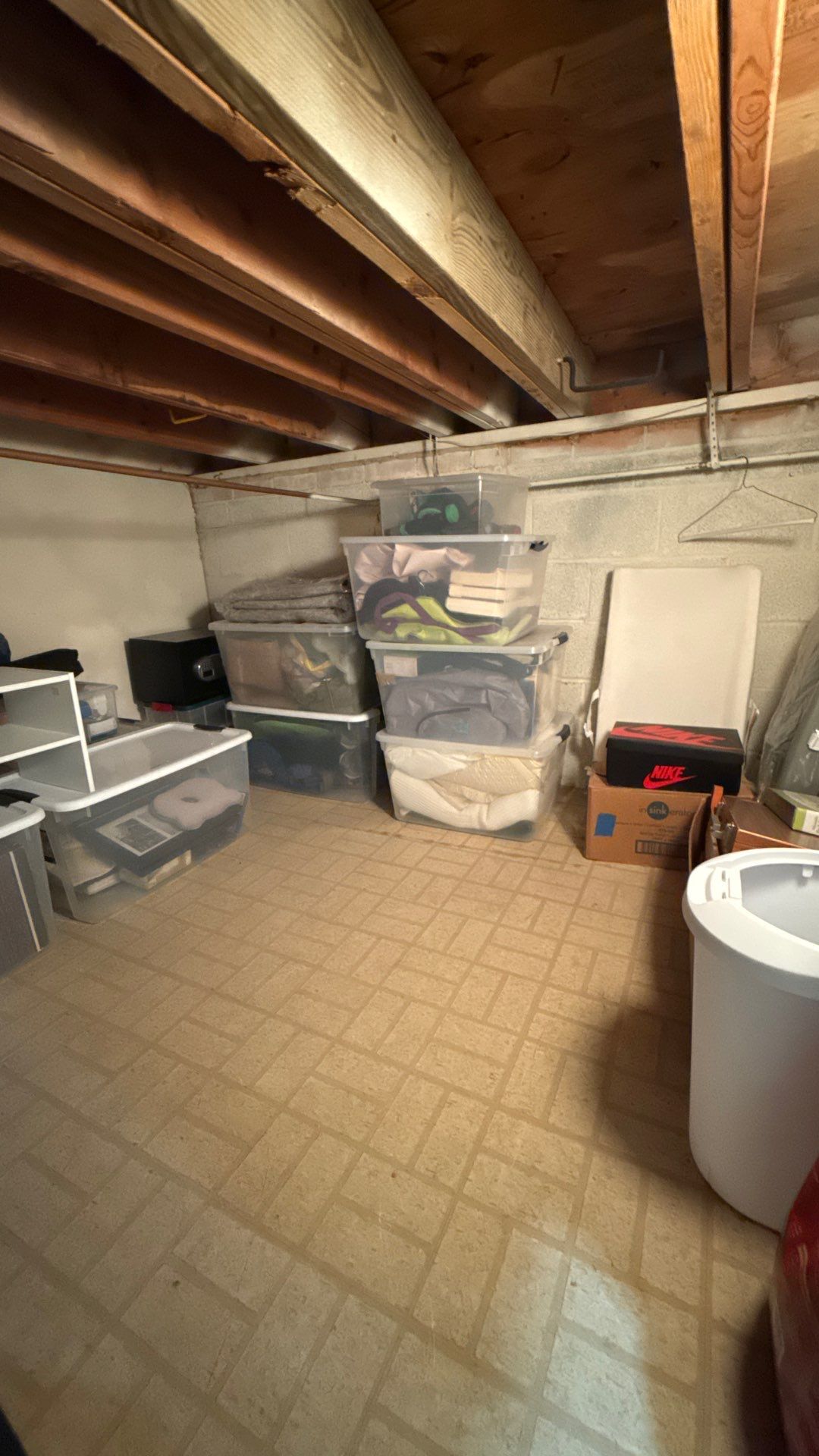 Drying process continuing with dehumidifiers and air movers targeting saturated building materials.