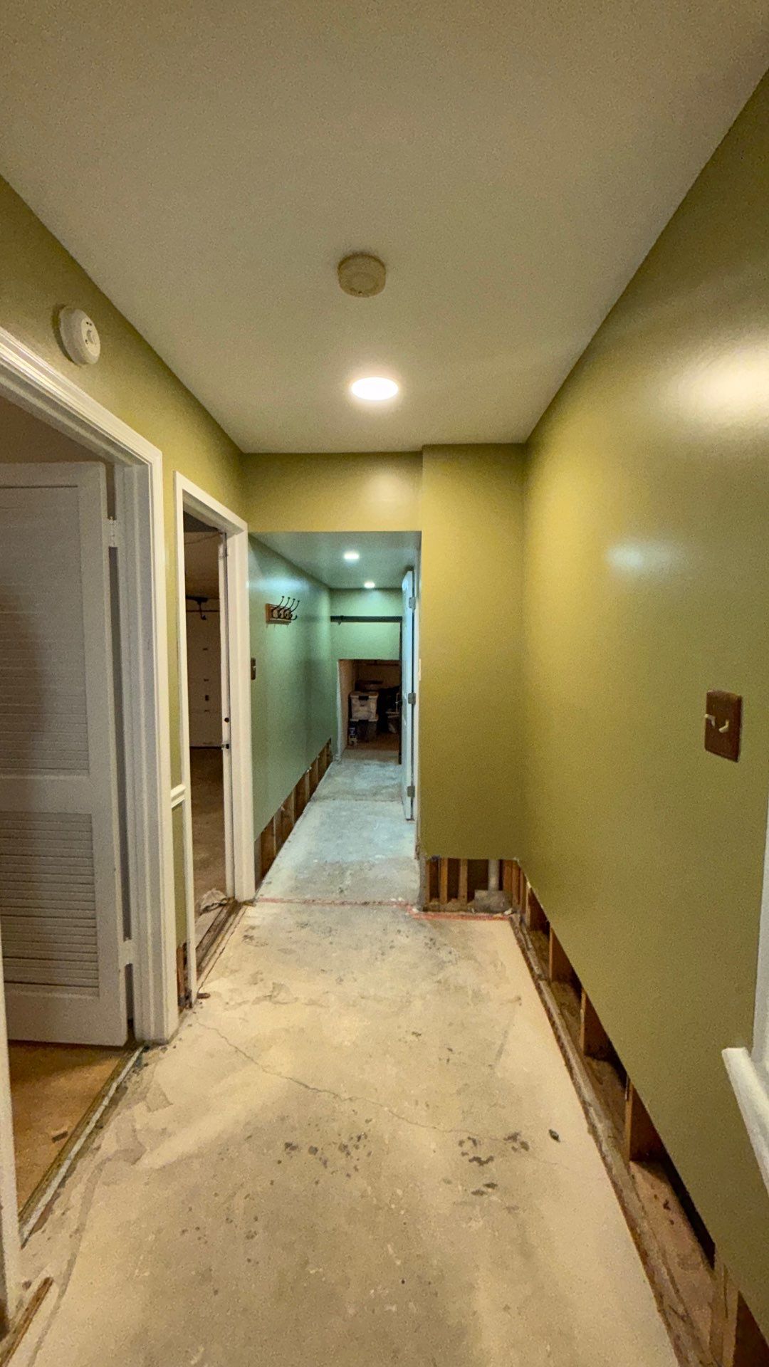 Wall section prepared for removal, showing extent of water damage to framing and substrate.
