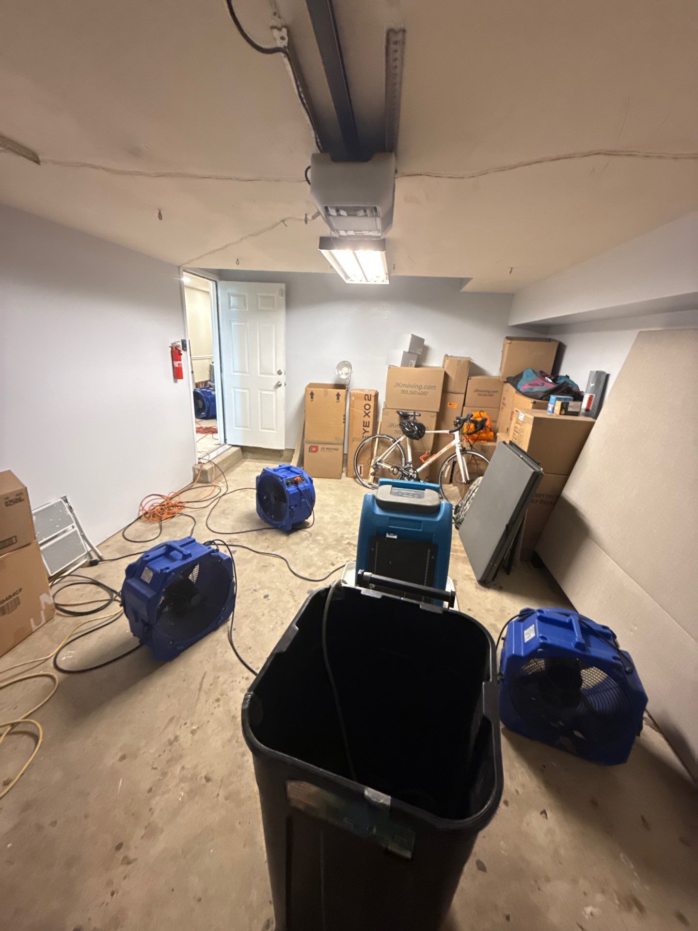 Standing water extraction underway in McLean water damage restoration, removing pooled water from affected interior space.