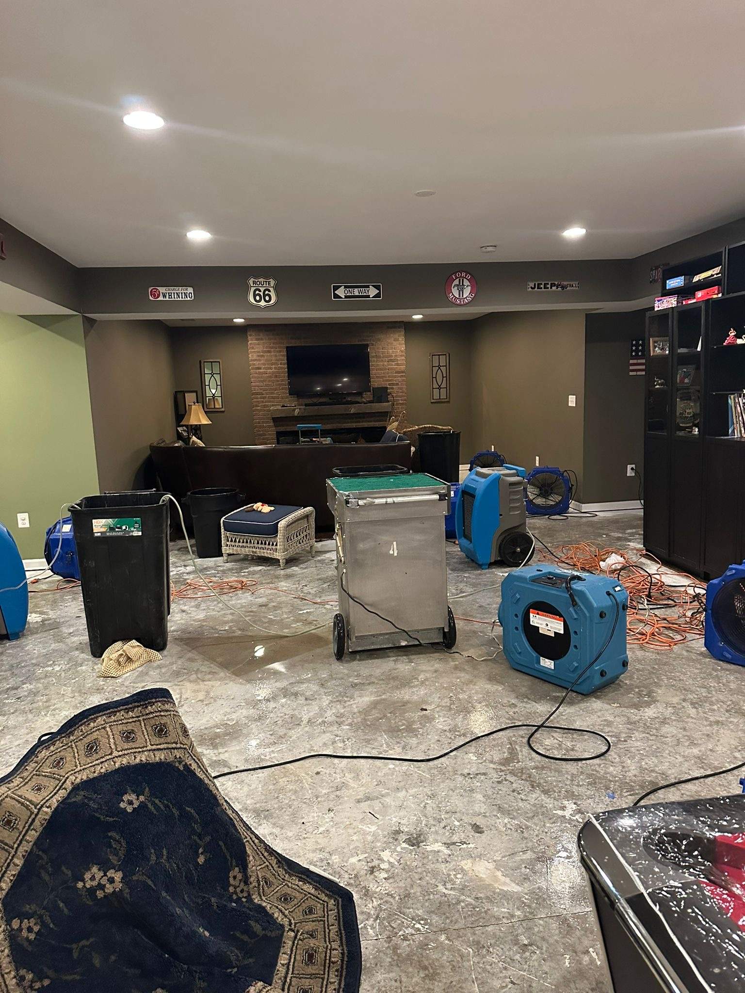 Dehumidification and air movement equipment positioned for structural drying in water-damaged space.