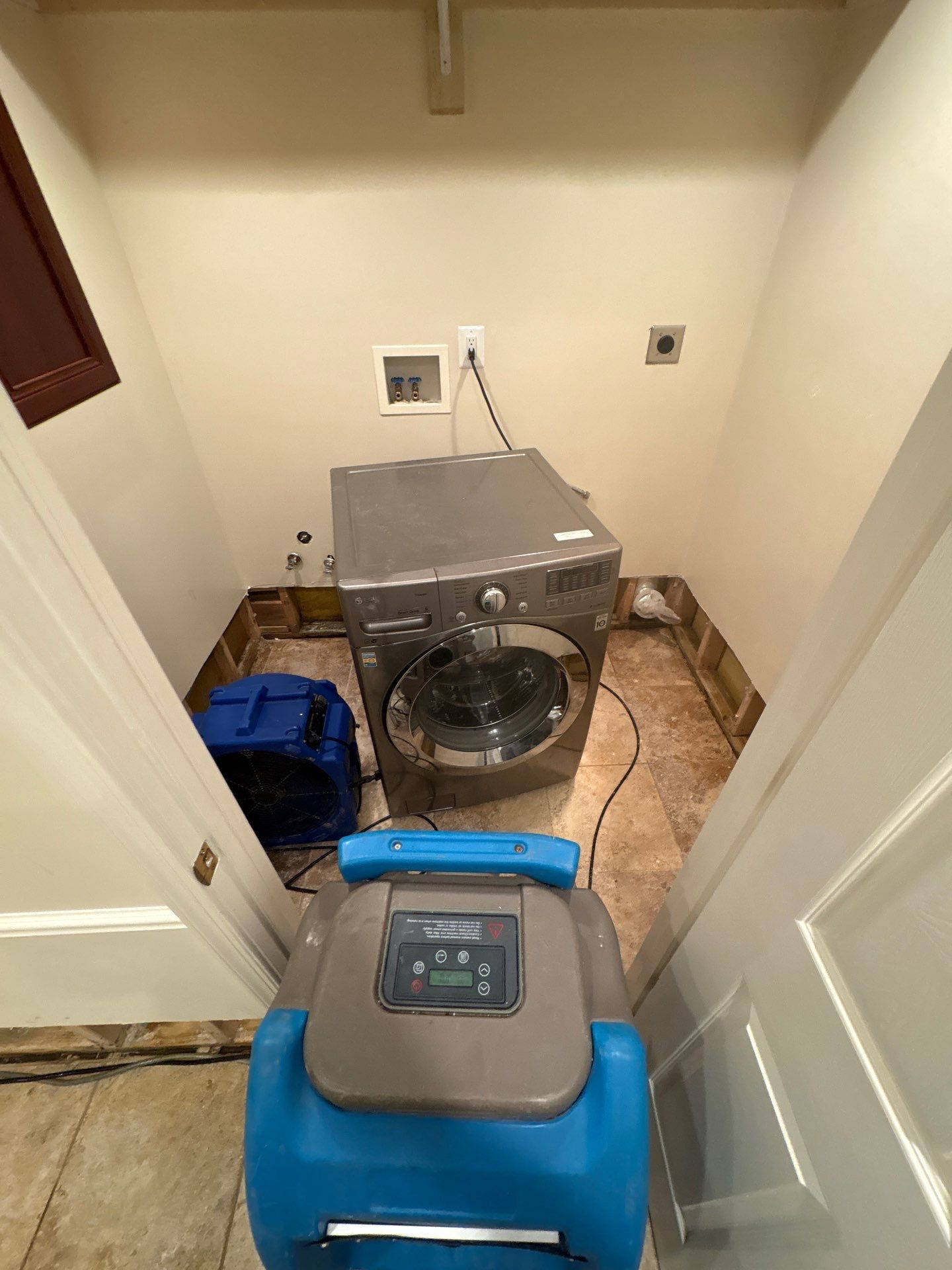 Standing water removal underway in Great Falls water damage restoration, extractors deployed across wet flooring.