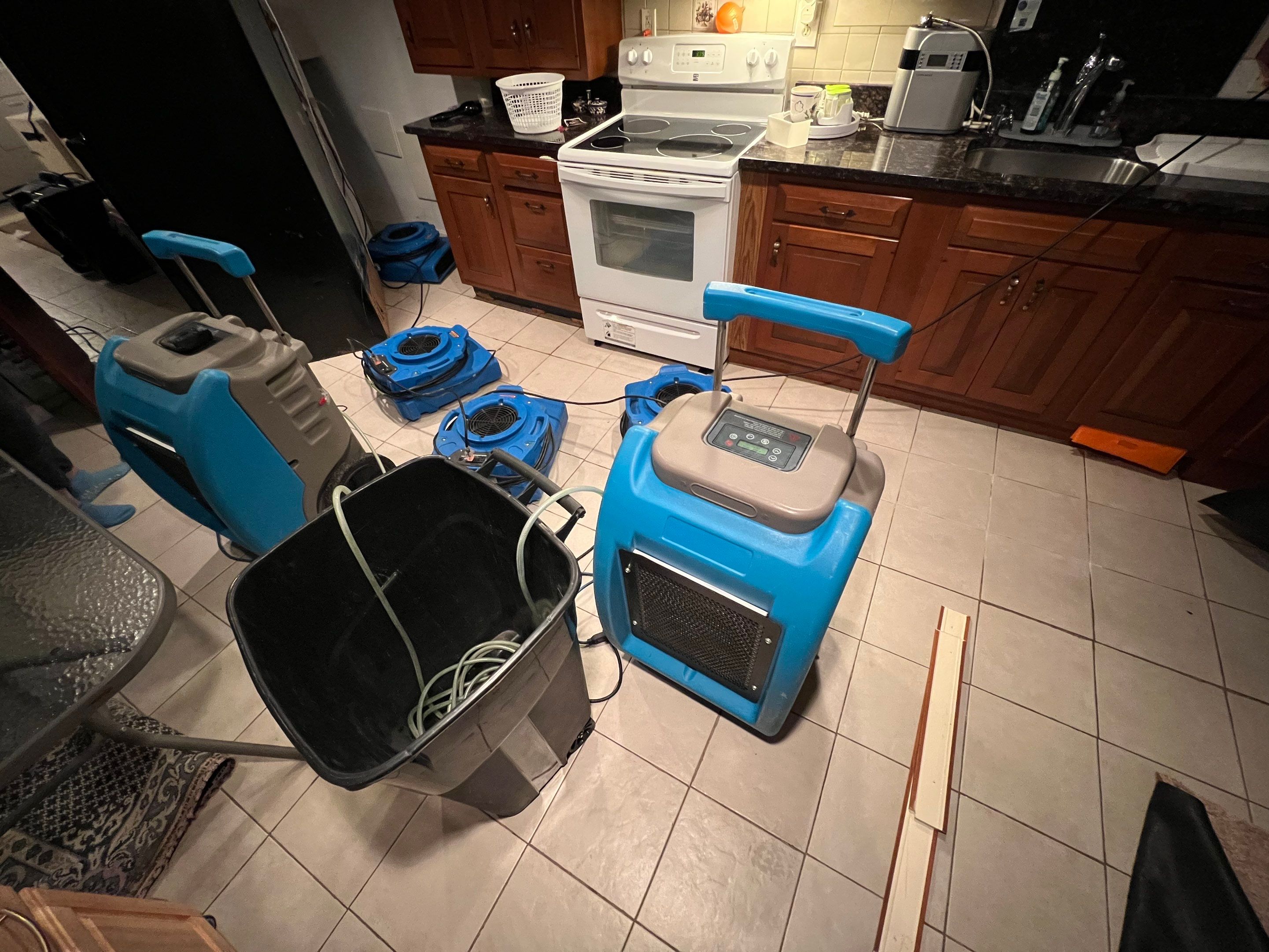 Dehumidification equipment positioned for structural drying during moisture remediation.