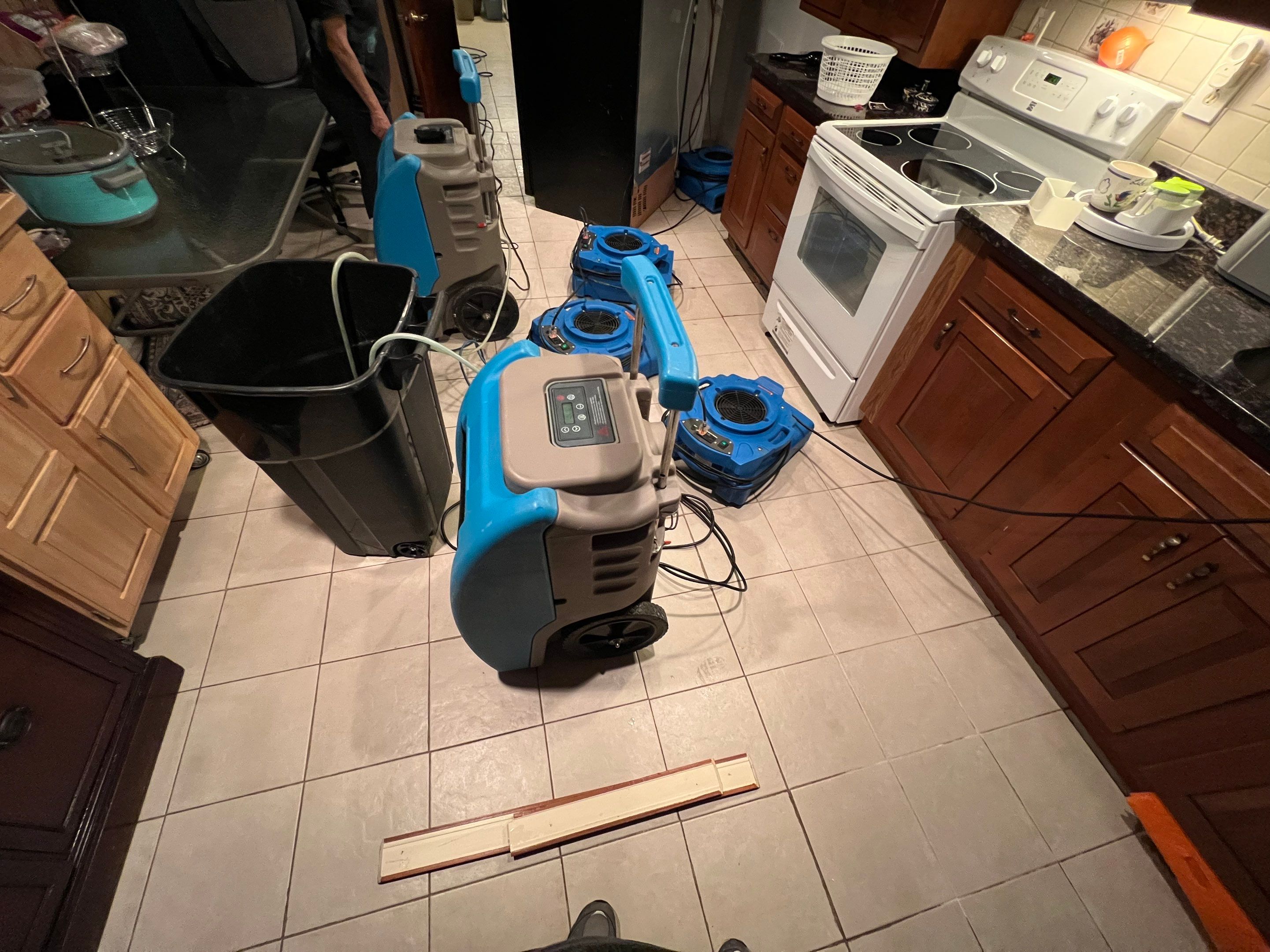 Structural drying setup with equipment monitoring moisture levels throughout the space.