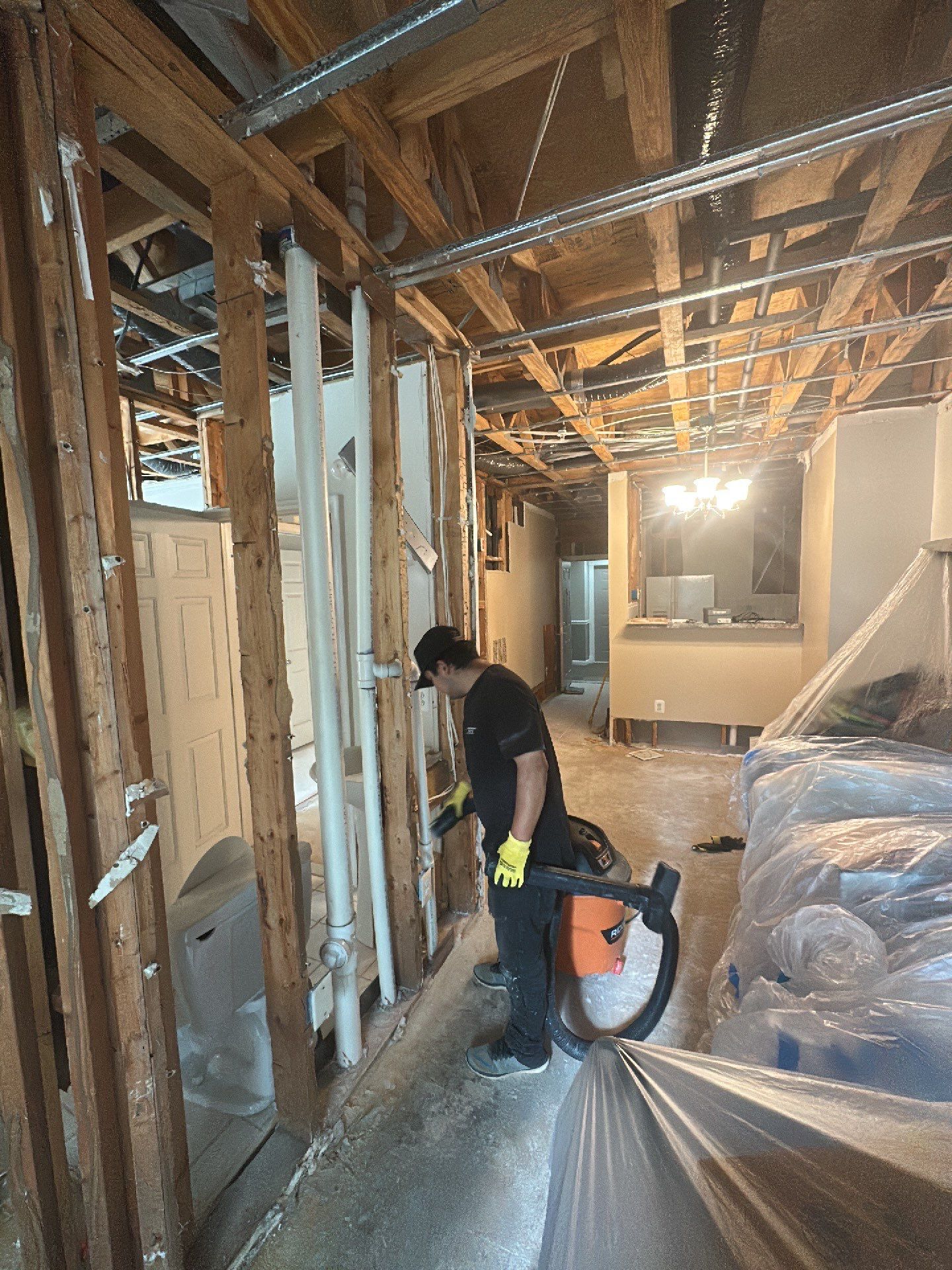 Standing water removal underway in Vienna water damage restoration, extractors deployed across wet flooring.