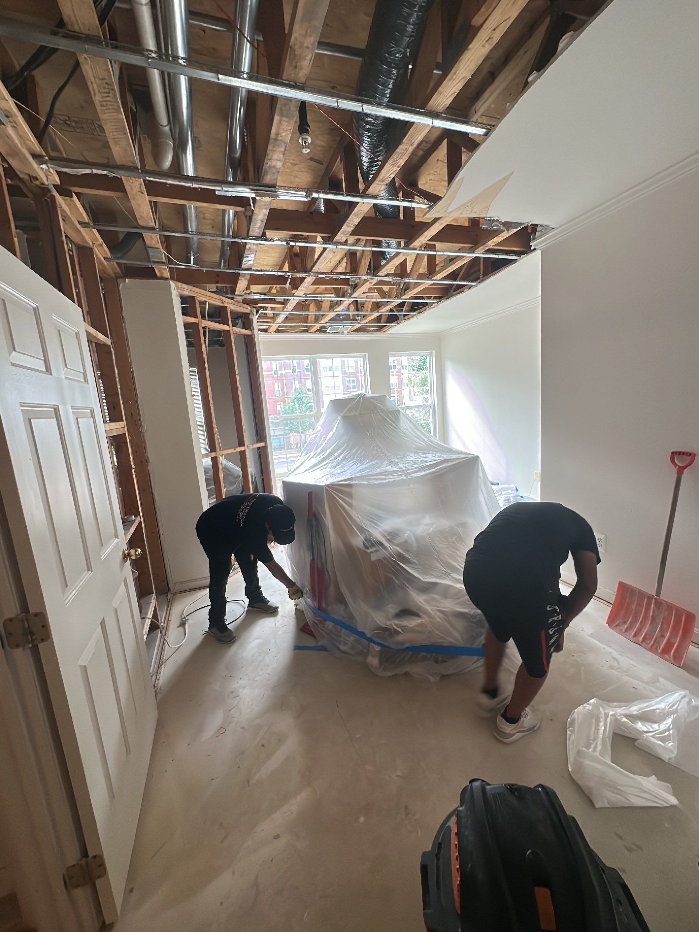 Ceiling damage assessment and preparation for repair work following water extraction and initial drying.