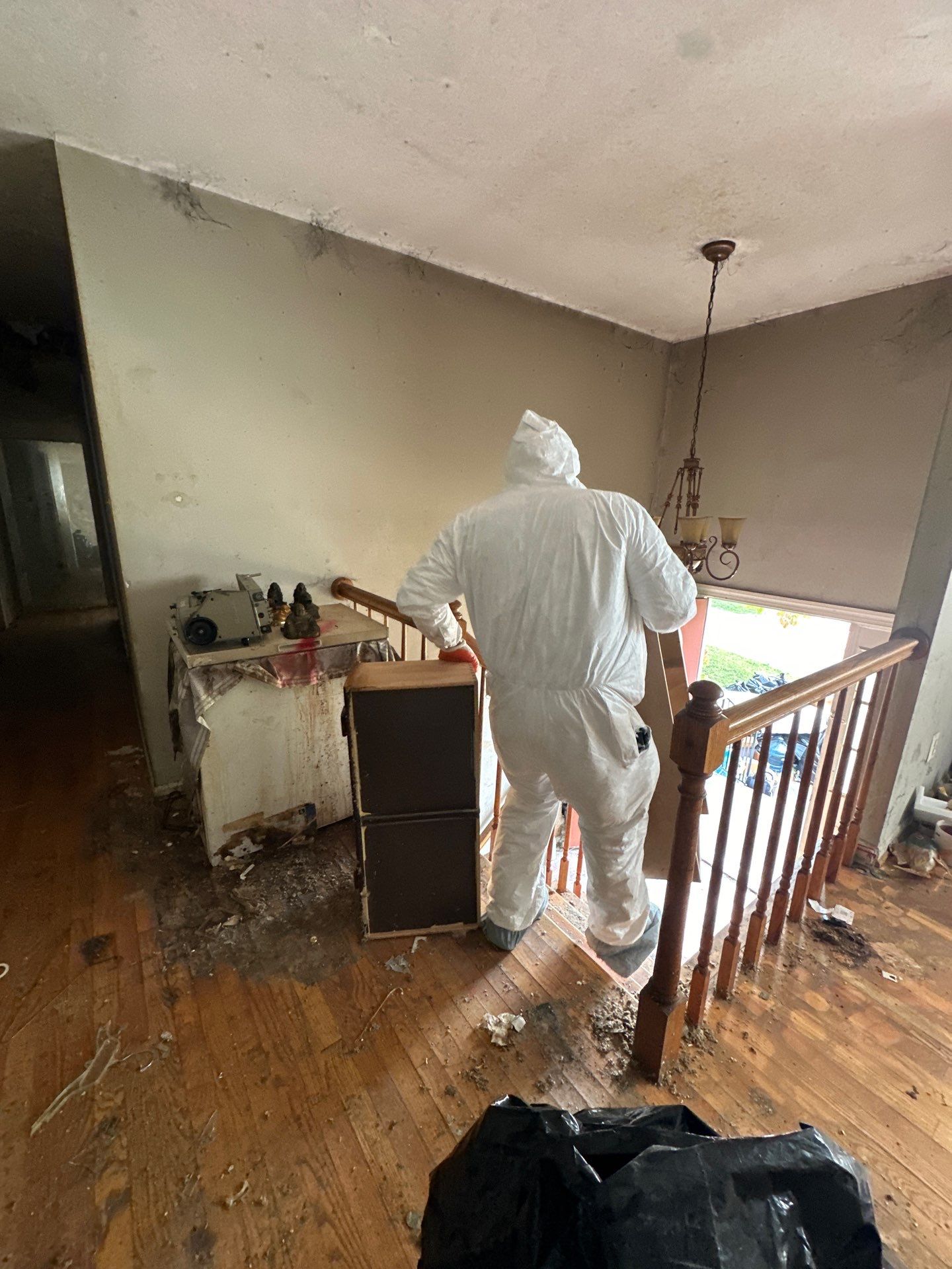 Water damage restoration in Annandale: wet drywall and flooring with dehumidifiers positioned for structural drying.