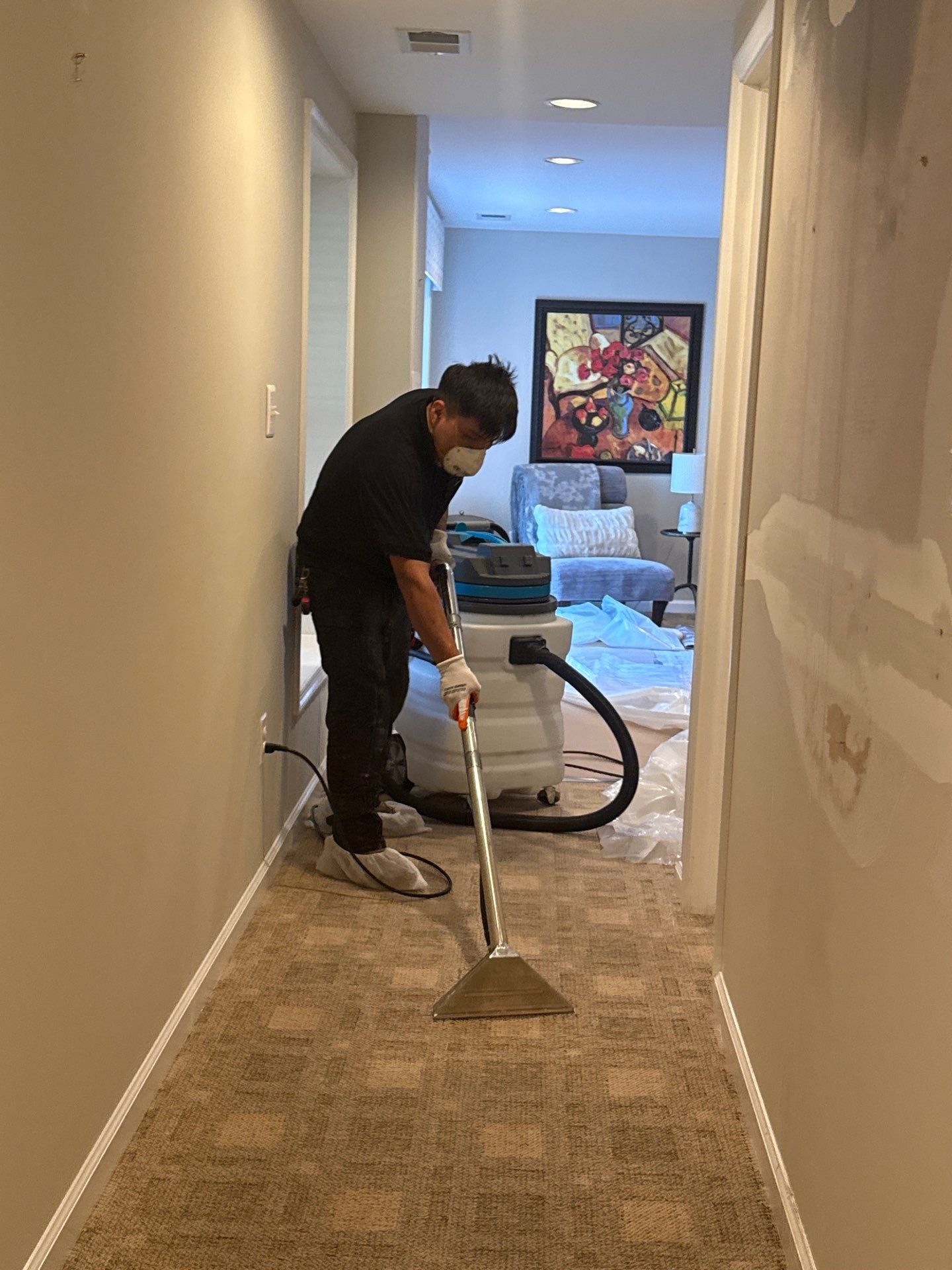 Standing water removal underway in Herndon mold remediation, carpet and ceiling damage visible.