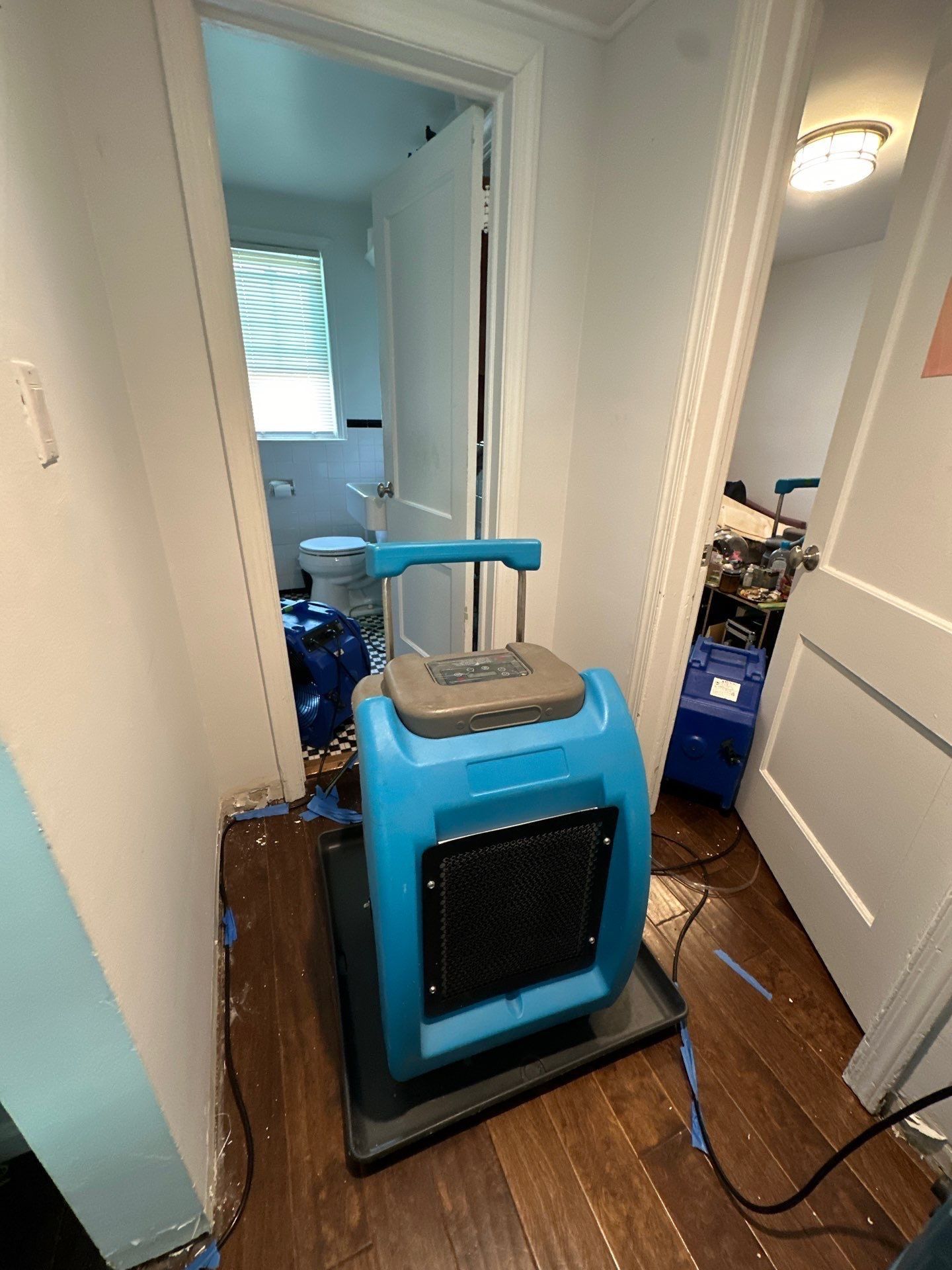 Mid-stage drying operation showing dehumidifiers and air movers positioned throughout affected Vienna residence.