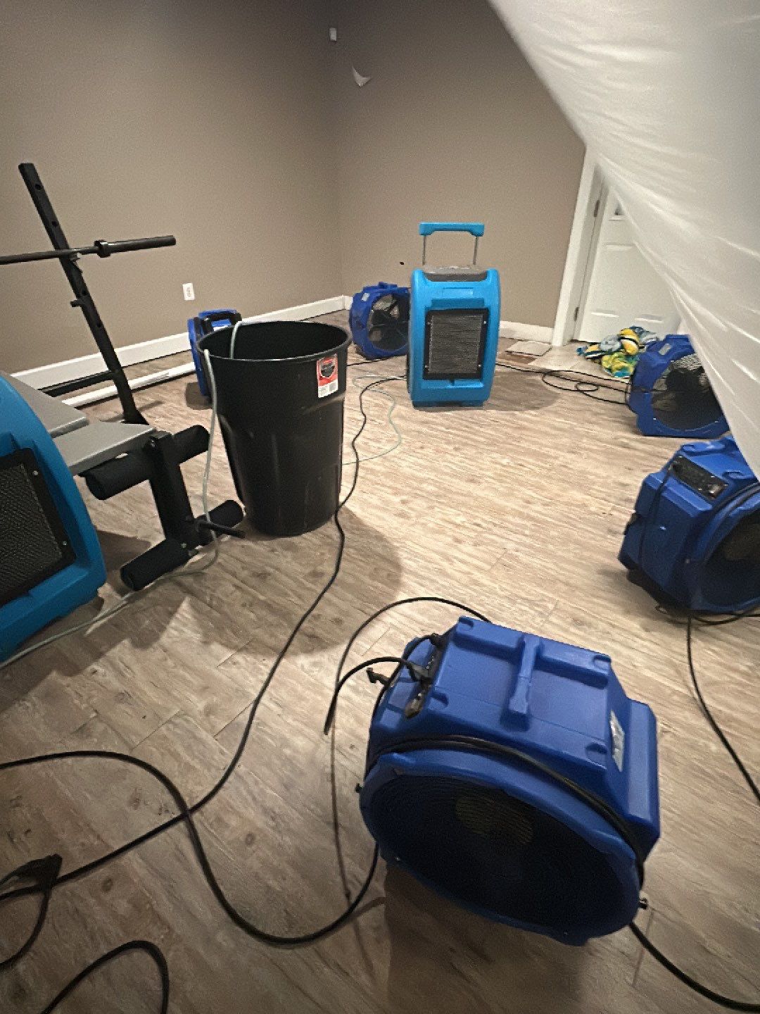 Mid-stage drying with dehumidification equipment monitoring moisture removal from structural materials.