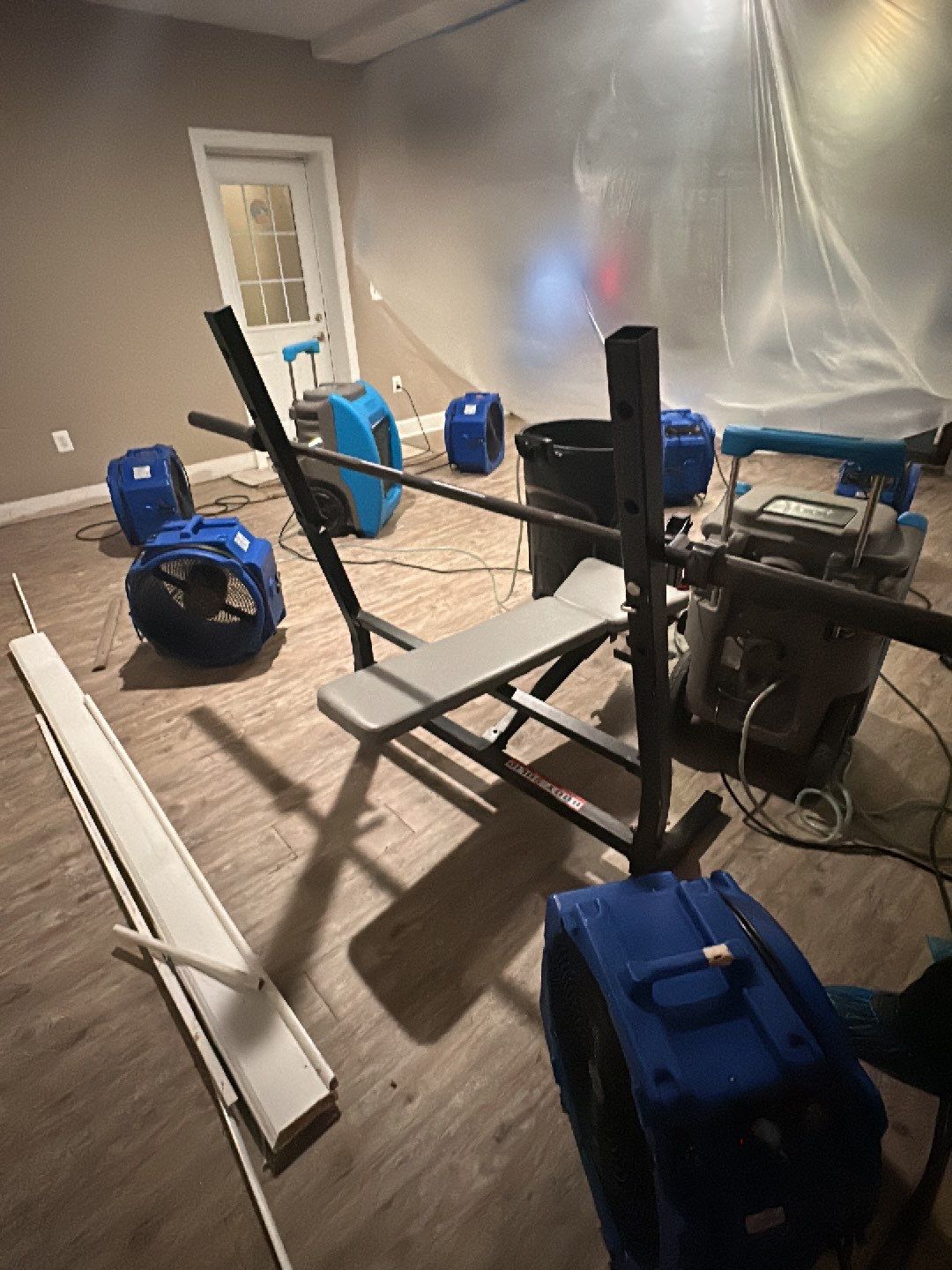 Containment barrier and dehumidification equipment set up during water damage restoration in Falls Church.