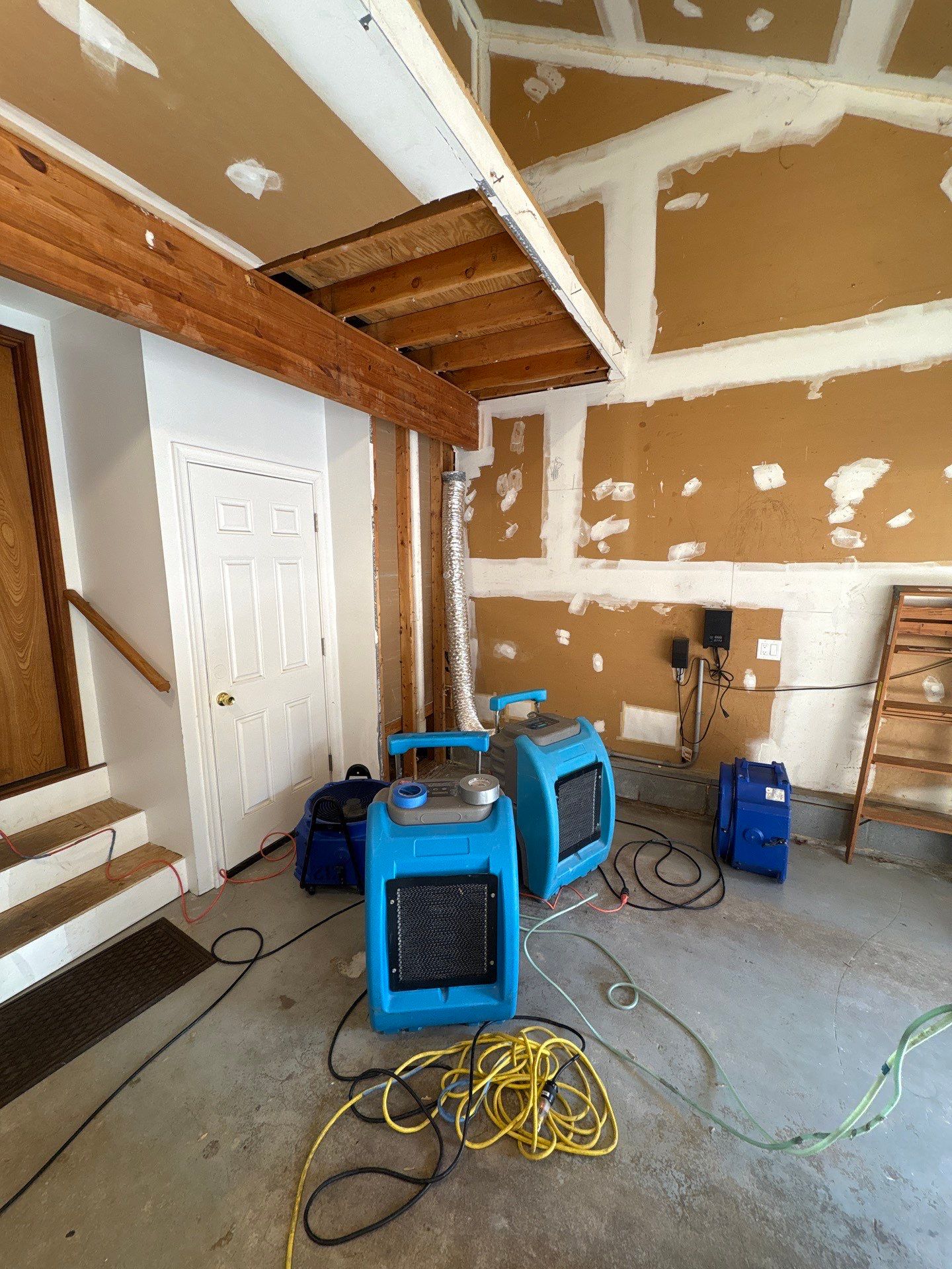 Ceiling cavity being prepared for sanitization as part of structural drying sequence.