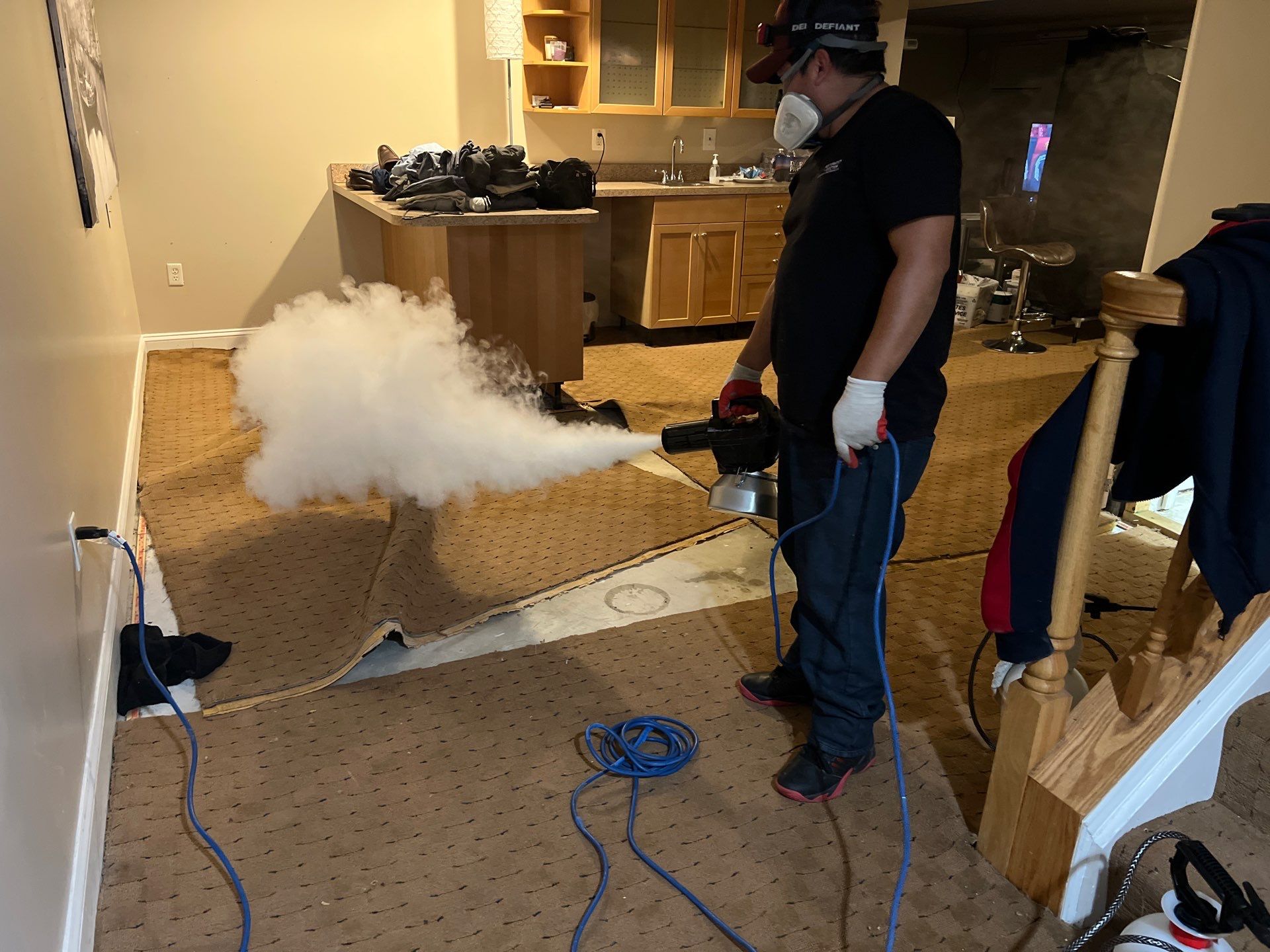 Mid-stage drying setup showing dehumidifiers and air movers working on affected flooring areas.